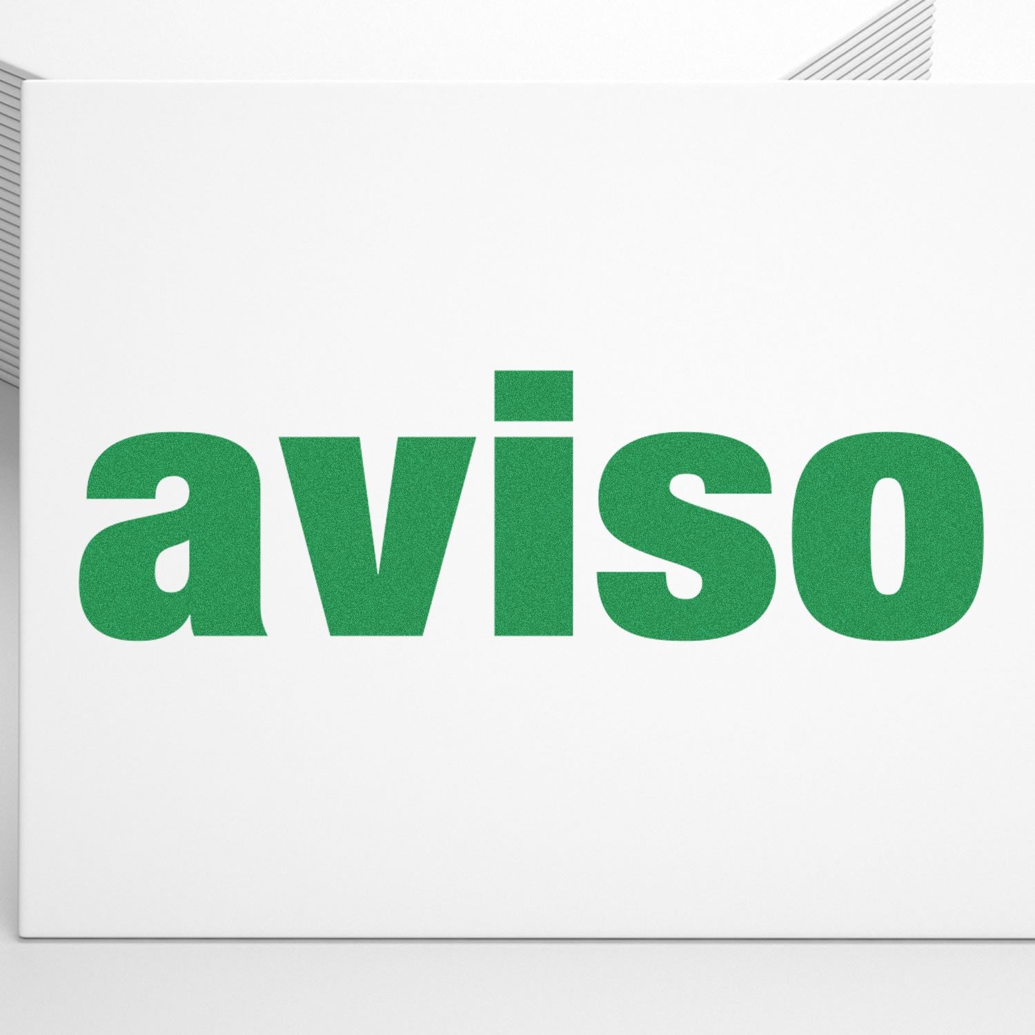 Green "aviso" text stamped on white paper using the Aviso Rubber Stamp, with a stack of papers in the background.