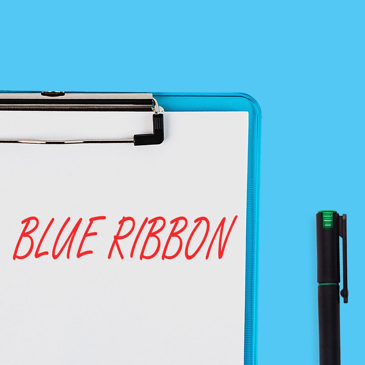 Slim Pre-Inked Blue Ribbon Teacher Stamp on white paper with a blue clipboard and black pen on a blue background.