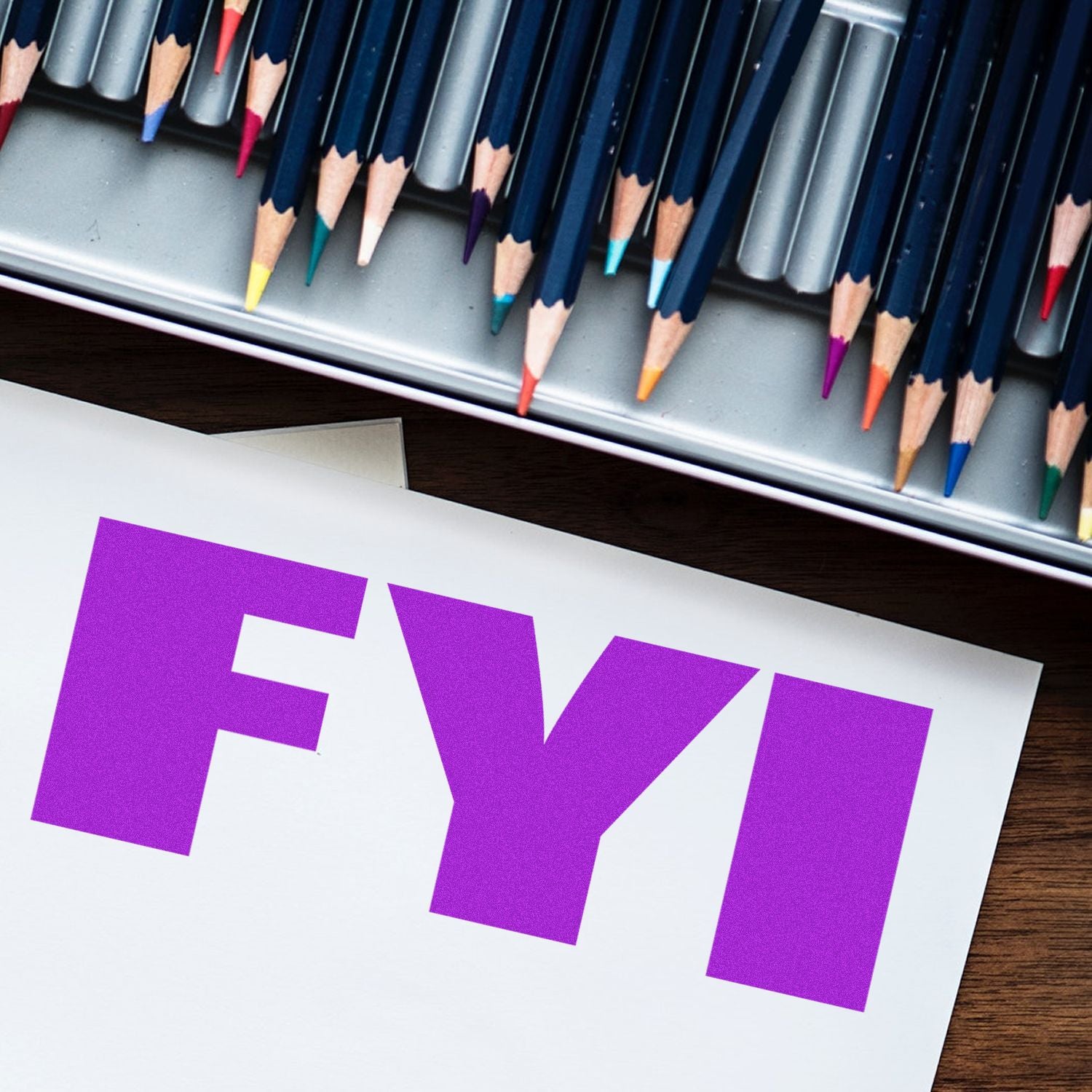 Large Self Inking Bold FYI Stamp in purple ink on white paper, with colored pencils in the background.