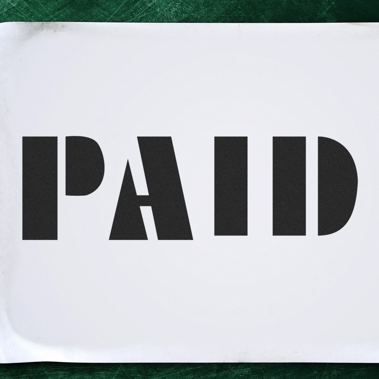 Large Bold Paid Rubber Stamp imprint on white paper, displaying the word PAID in large, bold black letters against a green background.