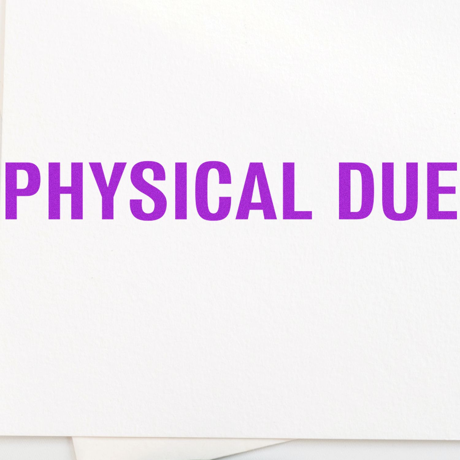 Bold Physical Due Rubber Stamp in use, displaying the text 'PHYSICAL DUE' in bold purple letters on a white background.