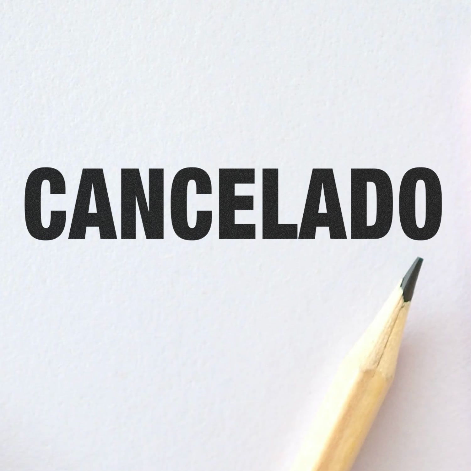 Cancelado rubber stamp impression on white paper with a pencil tip visible in the corner.