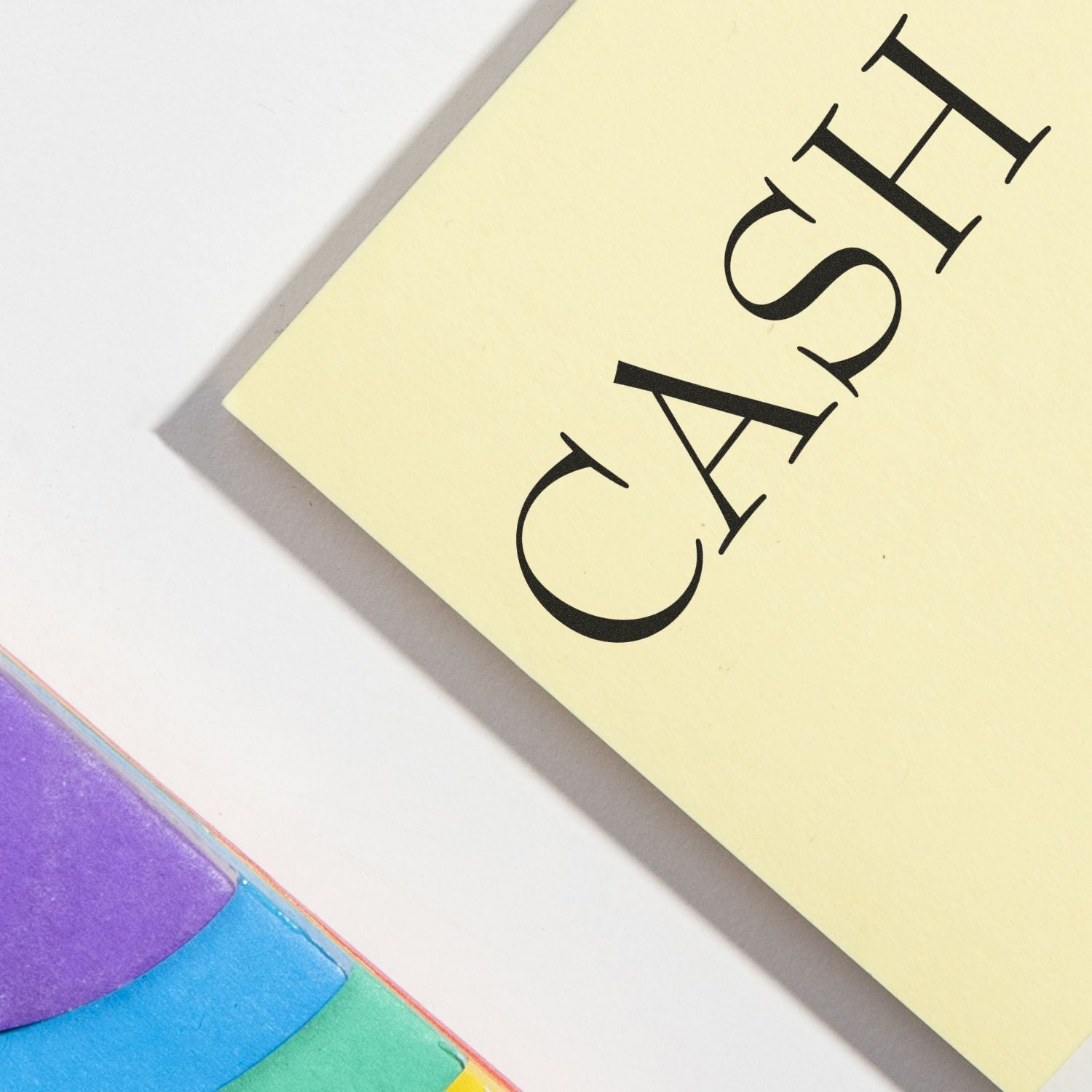 Large Pre-Inked Cash Stamp marking the word CASH on a yellow paper, with colorful sticky notes in the background.