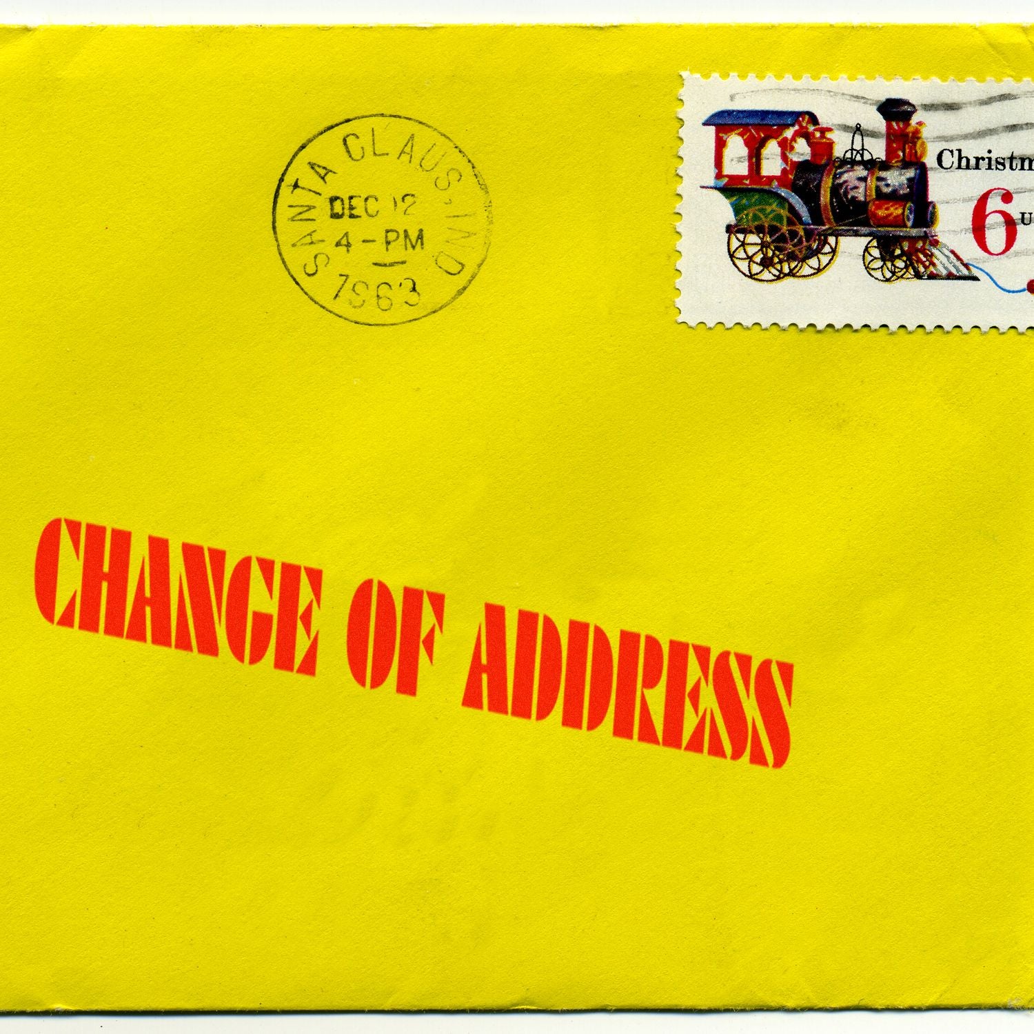 Yellow envelope with a red Change Of Address Rubber Stamp imprint, a Christmas stamp, and a Santa Claus postmark.