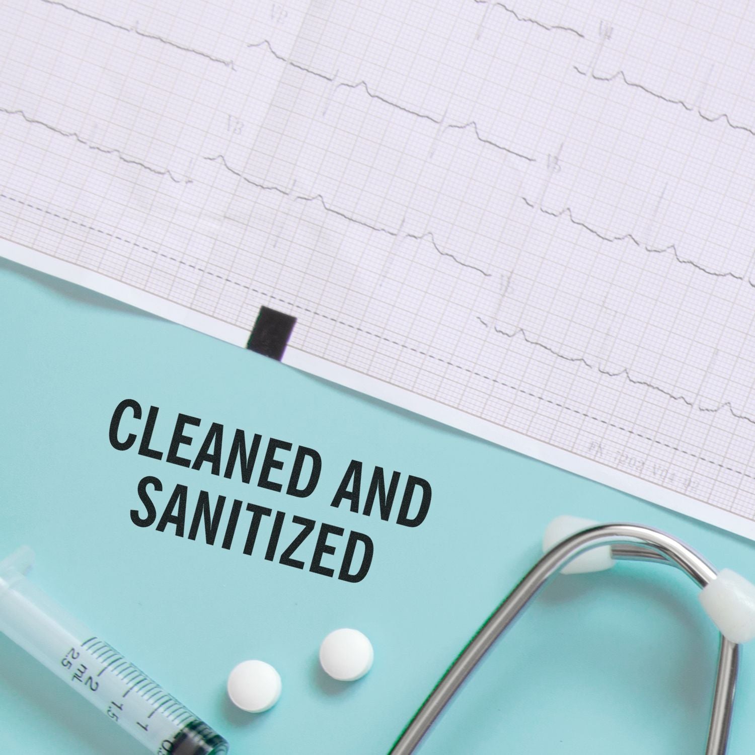 A Large Cleaned and Sanitized Rubber Stamp is used on a medical chart, with a stethoscope, syringe, and pills nearby.