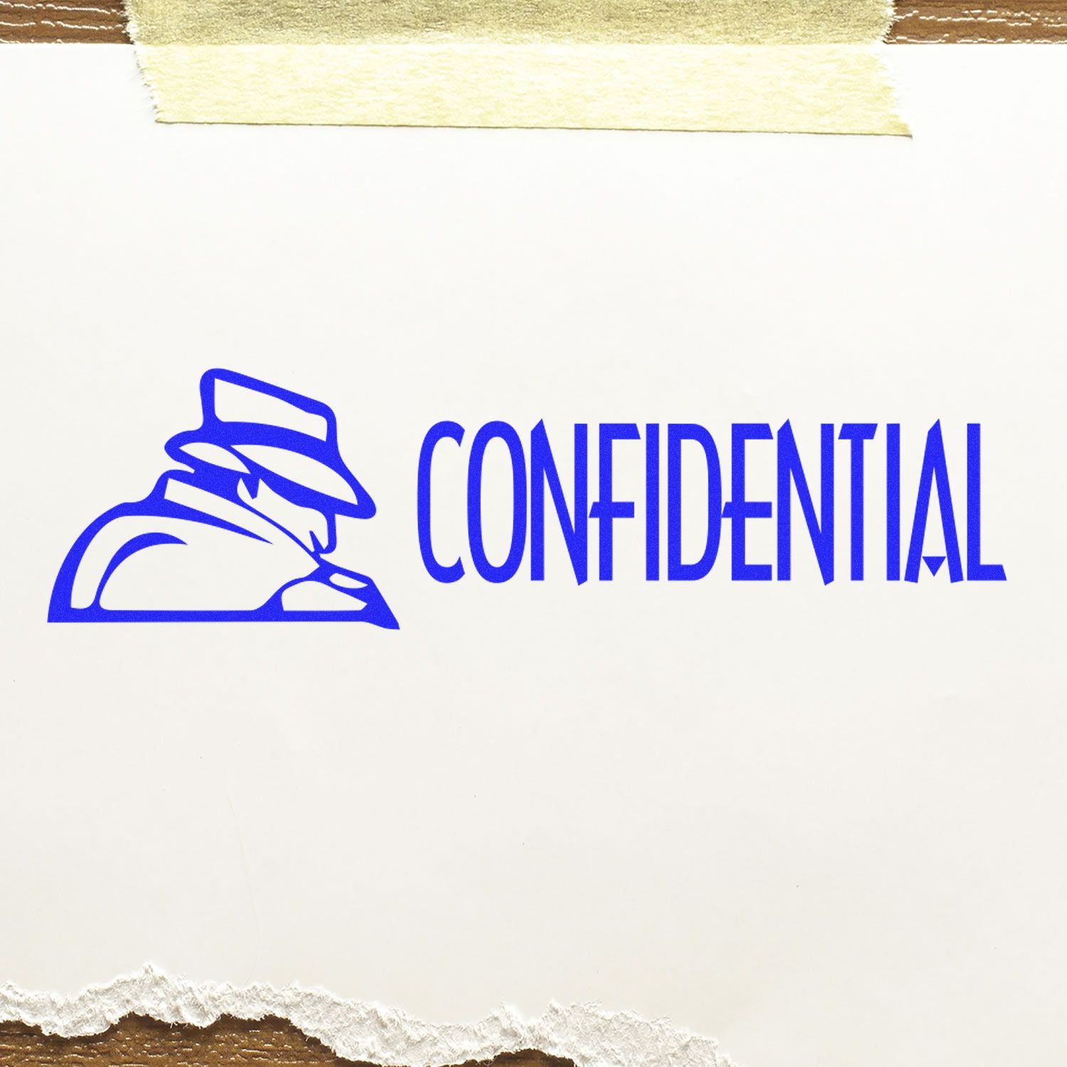 Confidential with Logo Rubber Stamp in use, showing a blue 'CONFIDENTIAL' text and a logo of a person in a hat on white paper.