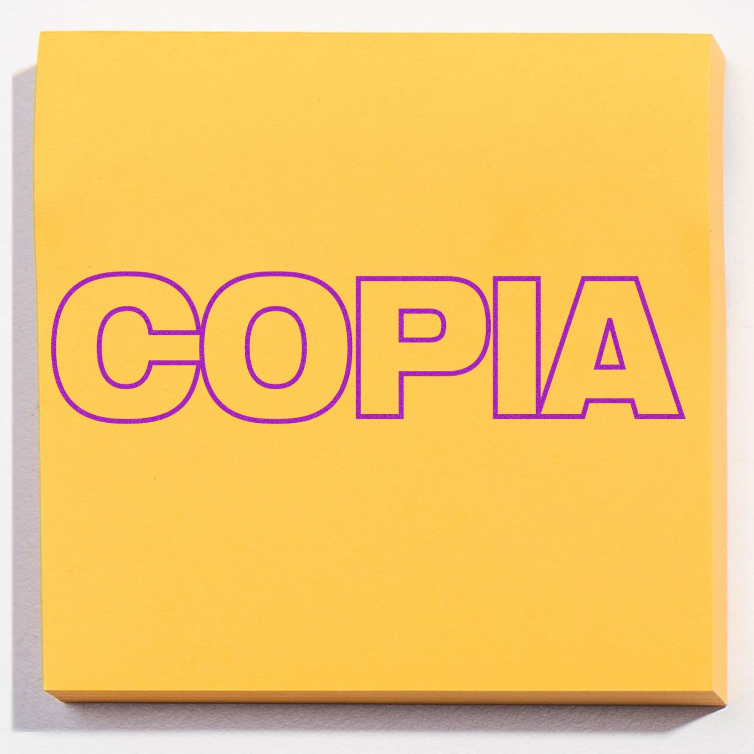 Yellow sticky note stamped with COPIA in purple ink using the Large Copia Rubber Stamp.