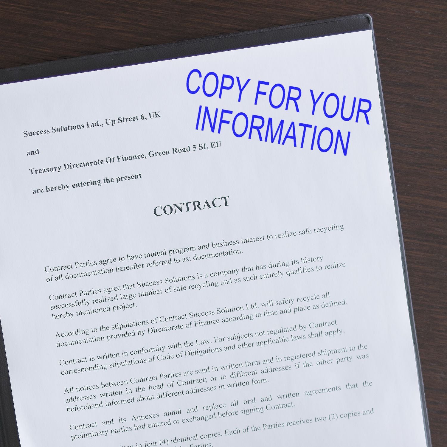 A document stamped with COPY FOR YOUR INFORMATION using the Large Self Inking Copy For Your Information Stamp on a wooden desk.