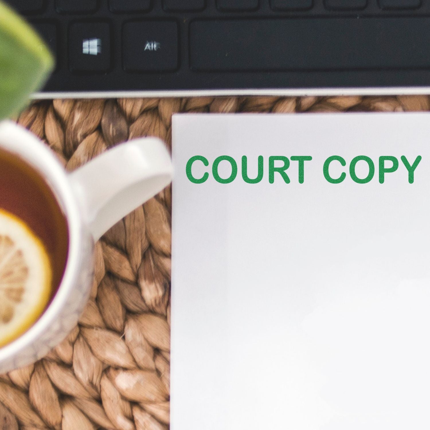 Court Copy Rubber Stamp in use on a white paper next to a cup of tea with a lemon slice and a keyboard in the background.