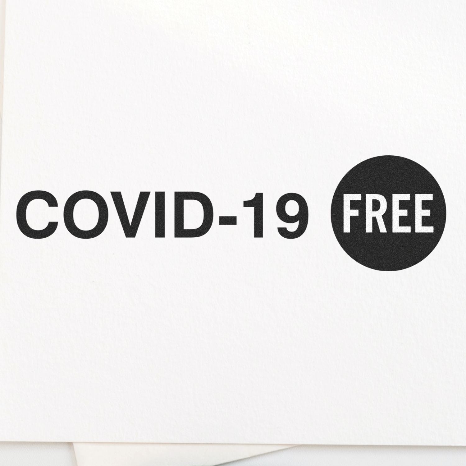 Large Covid-19 Rubber Stamp imprint on white paper, displaying COVID-19 FREE in bold black letters with a circular FREE symbol.