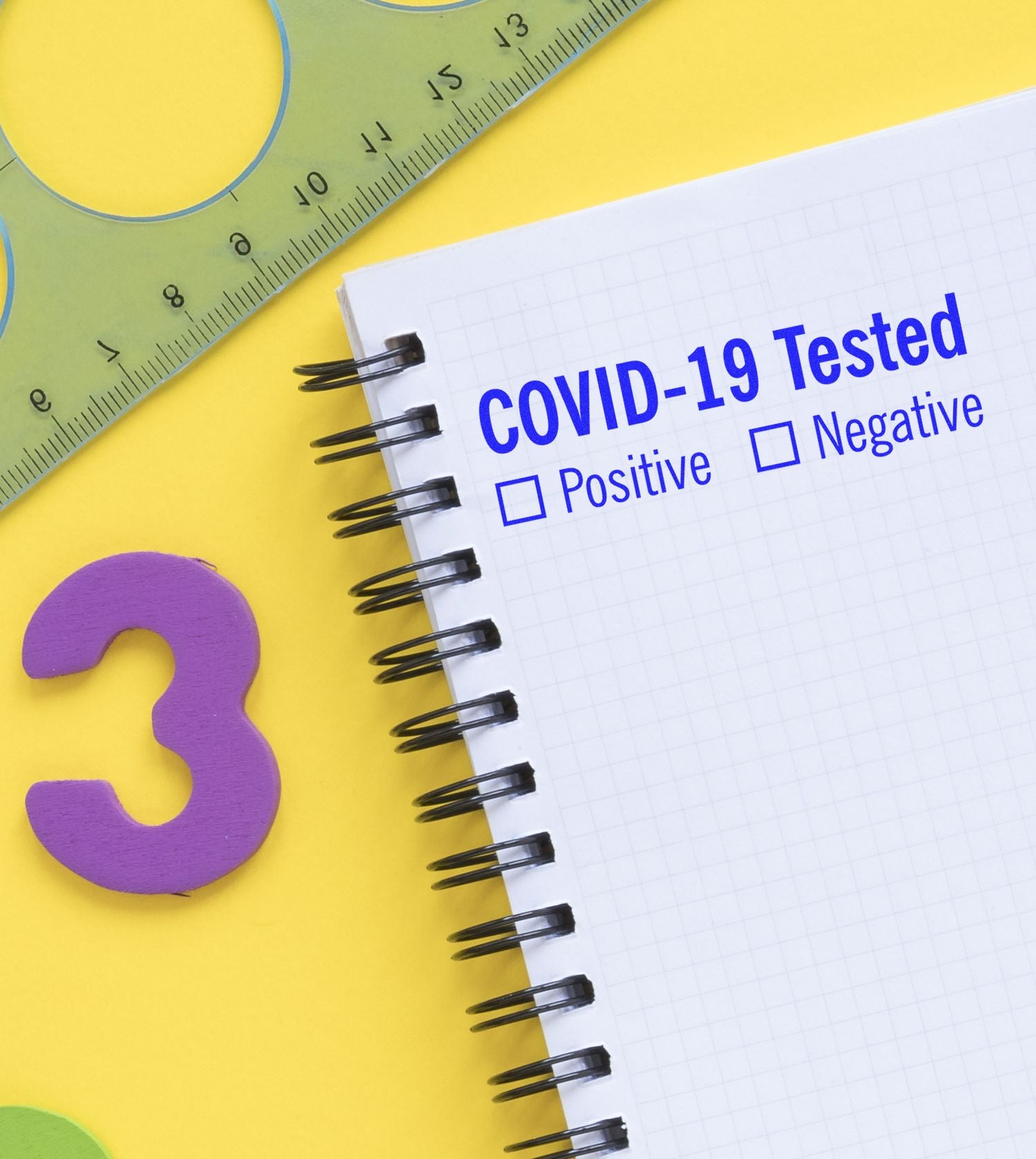 Slim Pre-Inked Covid-19 Tested Stamp used on a notebook with checkboxes for Positive and Negative results, next to a ruler and number 3.