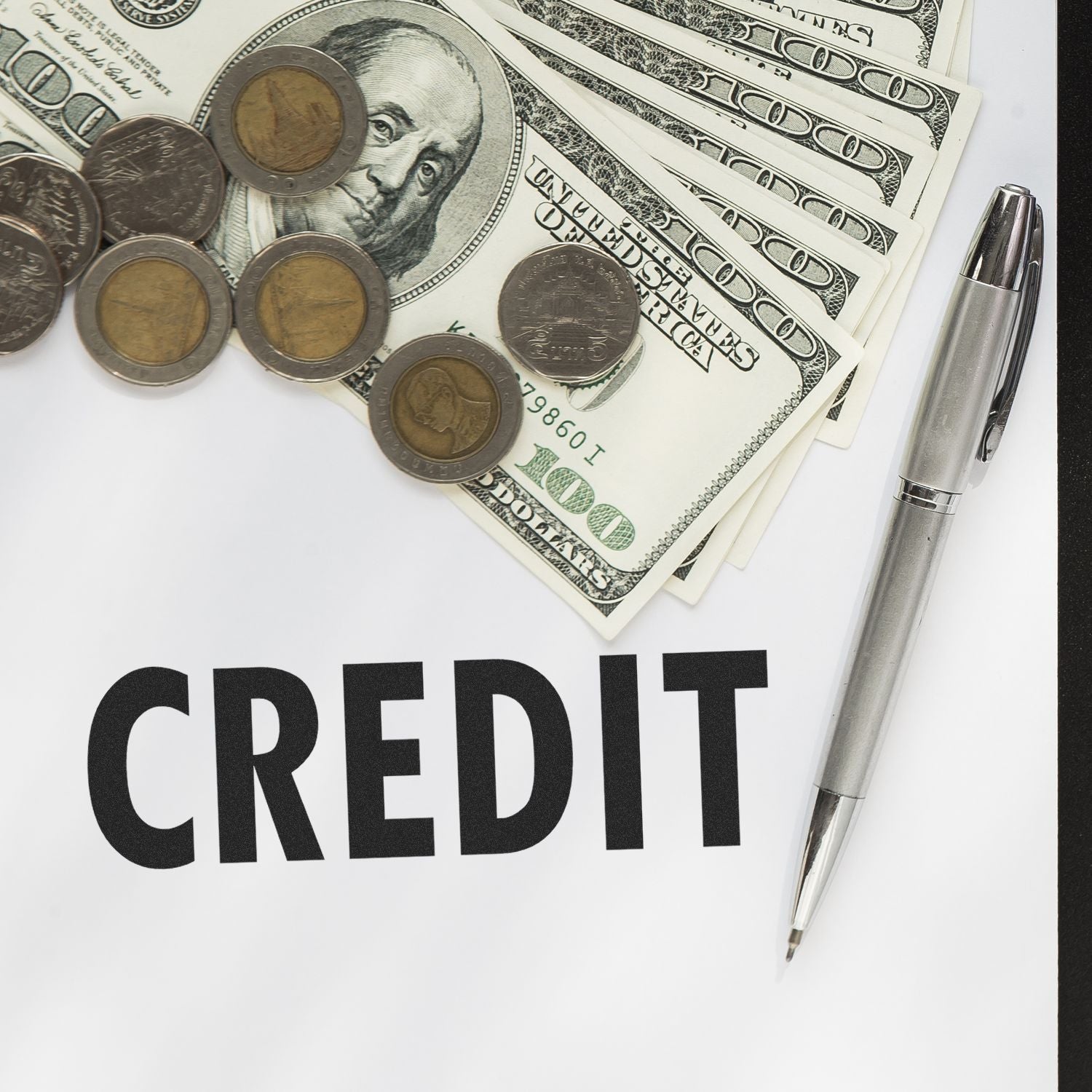 Self Inking Credit Stamp in use with a pen, coins, and dollar bills on a paper labeled CREDIT .