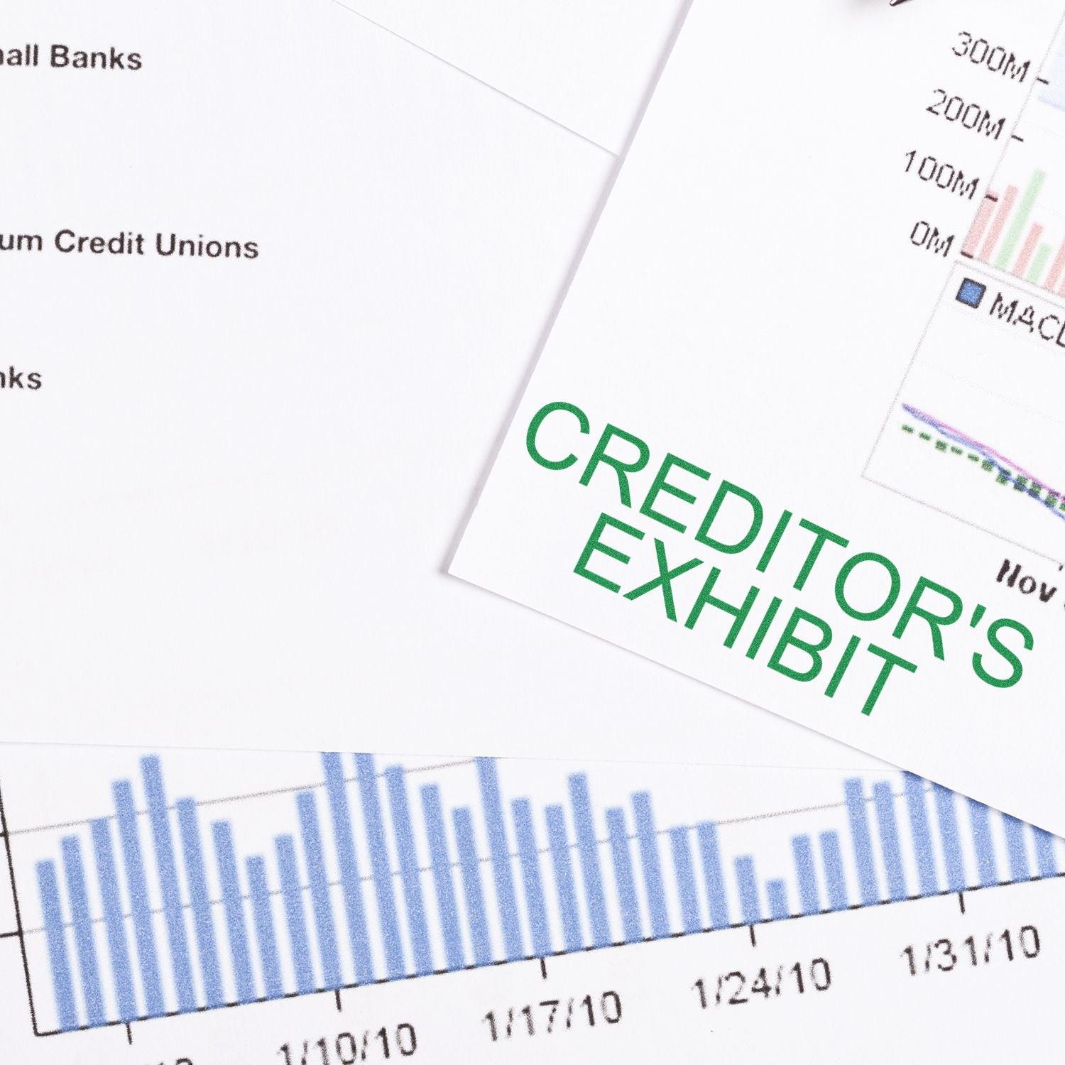 Self Inking Creditors Exhibit Stamp marking a document with graphs and charts in the background.