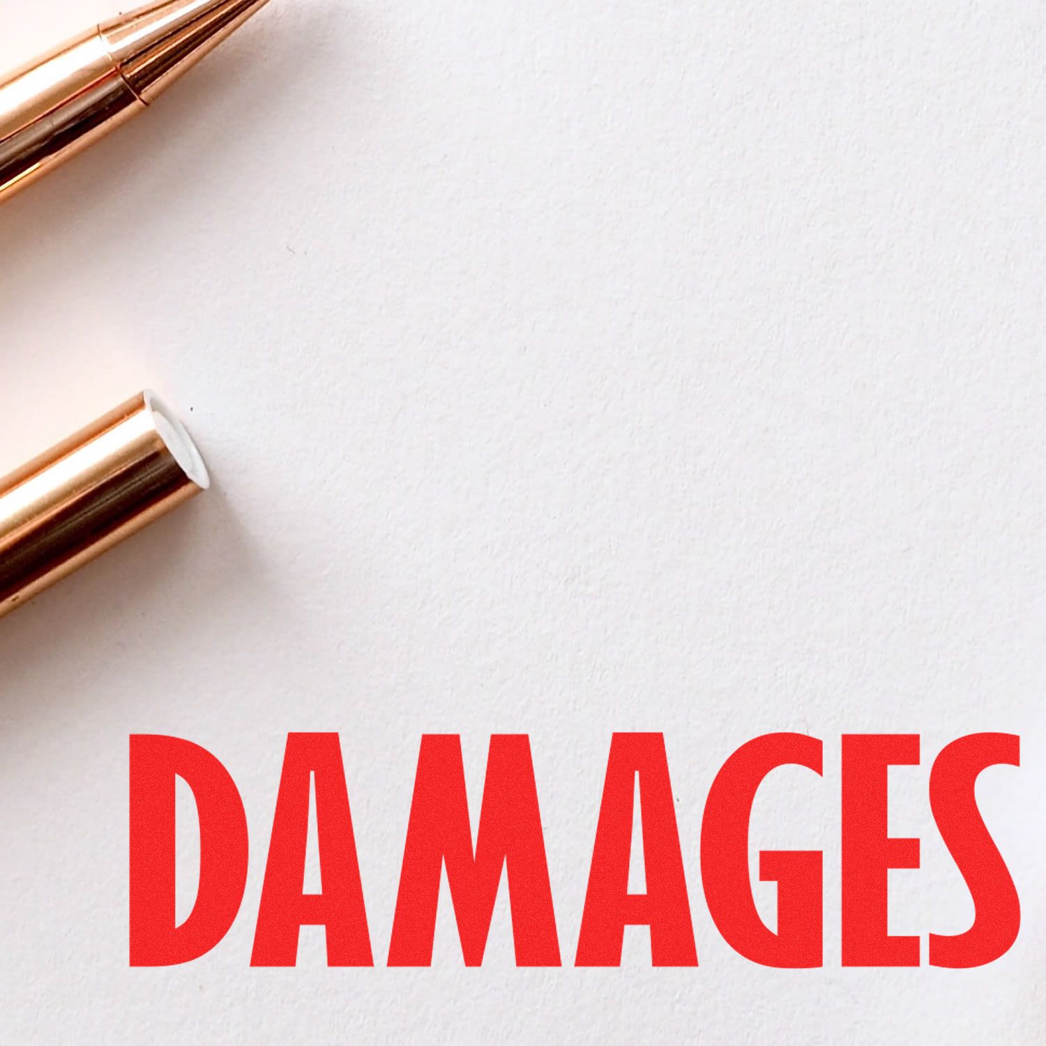 Legal Damages Rubber Stamp in use, with the word "DAMAGES" stamped in bold red ink on white paper, next to a gold pen.