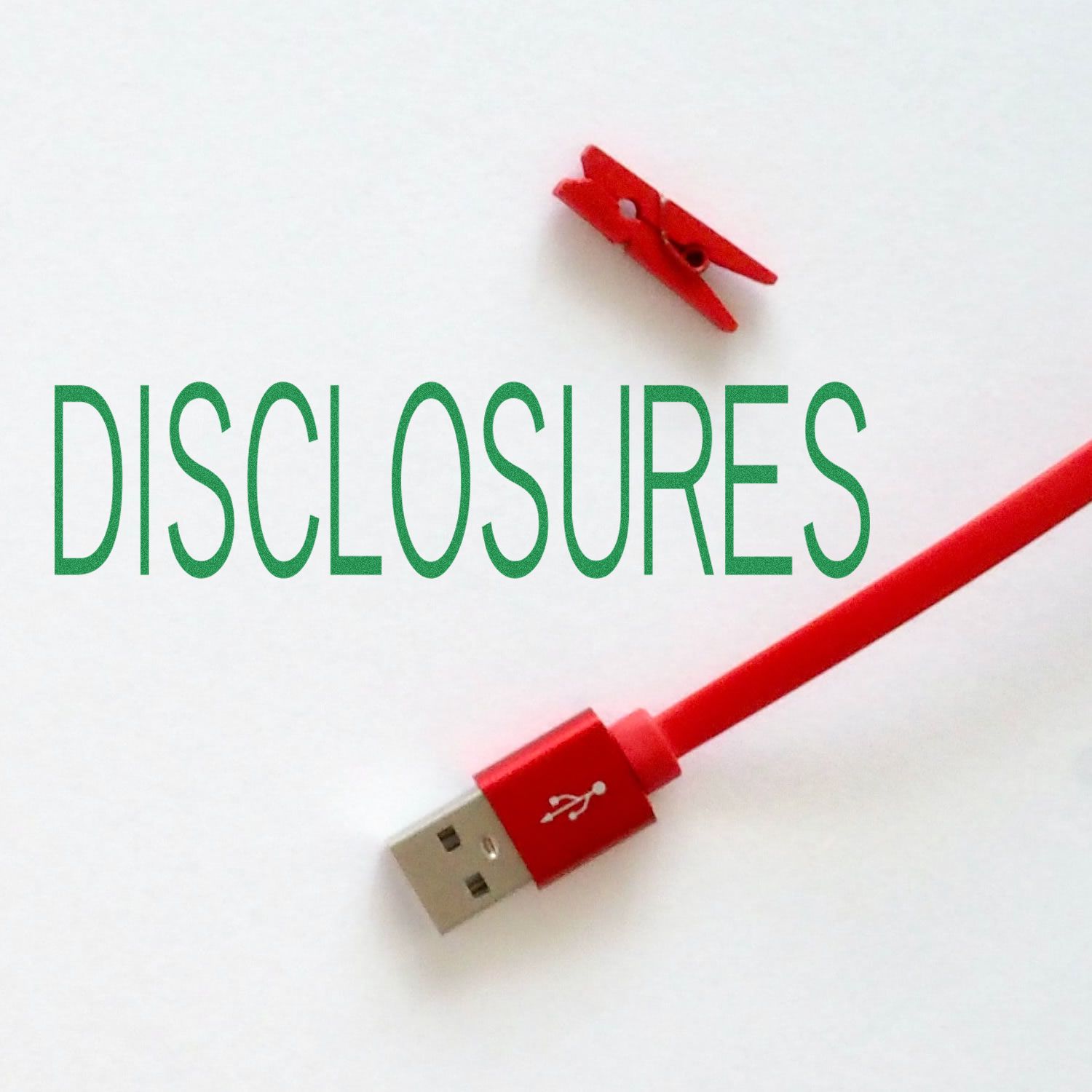 Large Pre-Inked Disclosures Stamp in use, stamping the word DISCLOSURES in green ink on a white surface, next to a red USB cable.