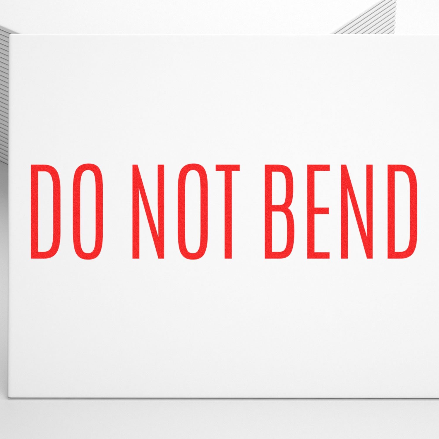 Slim Pre-Inked Do Not Bend Stamp in red ink on a white envelope, ensuring important documents remain flat and undamaged.