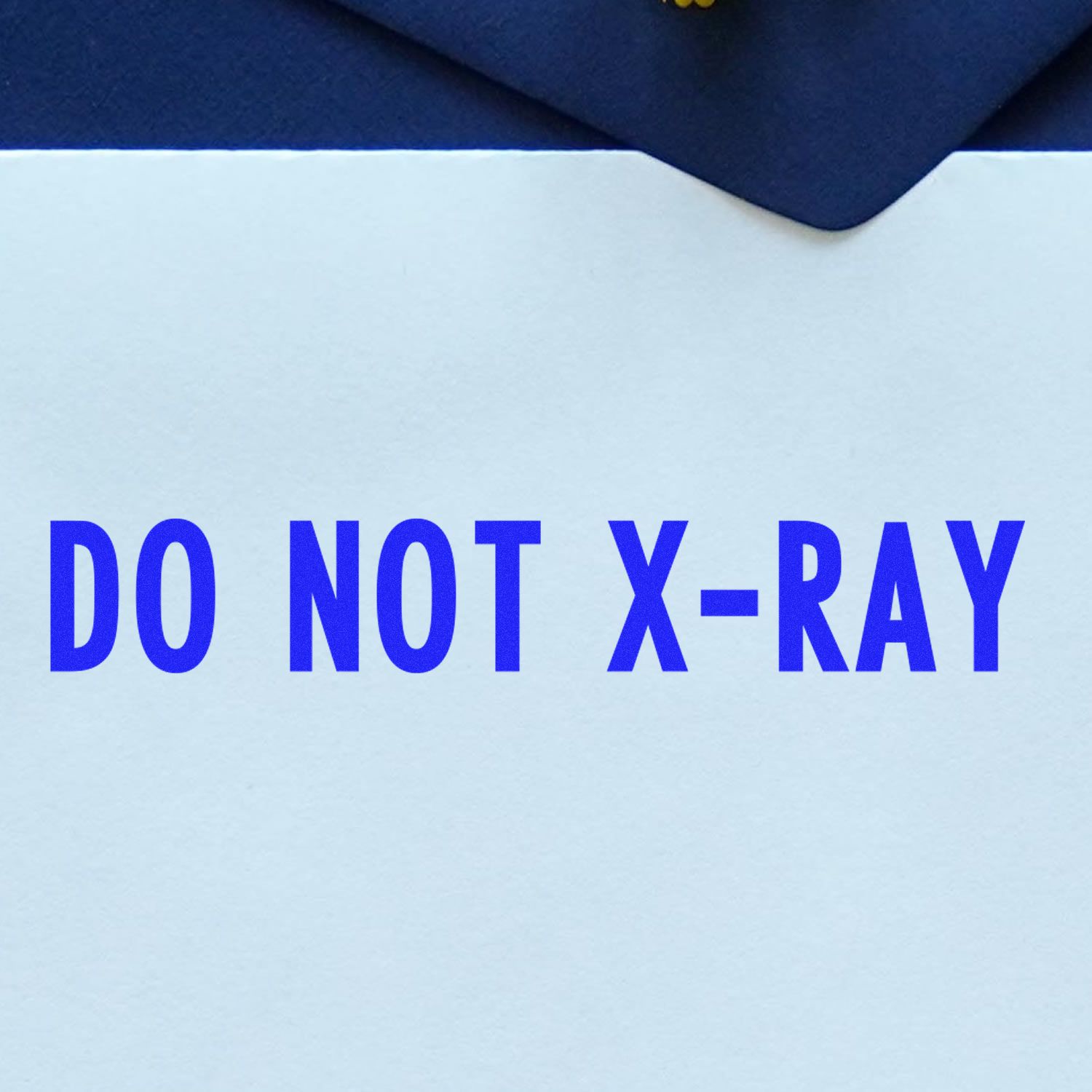 Slim Pre-Inked Do Not X-Ray Stamp in blue ink on a white envelope, emphasizing the message DO NOT X-RAY.