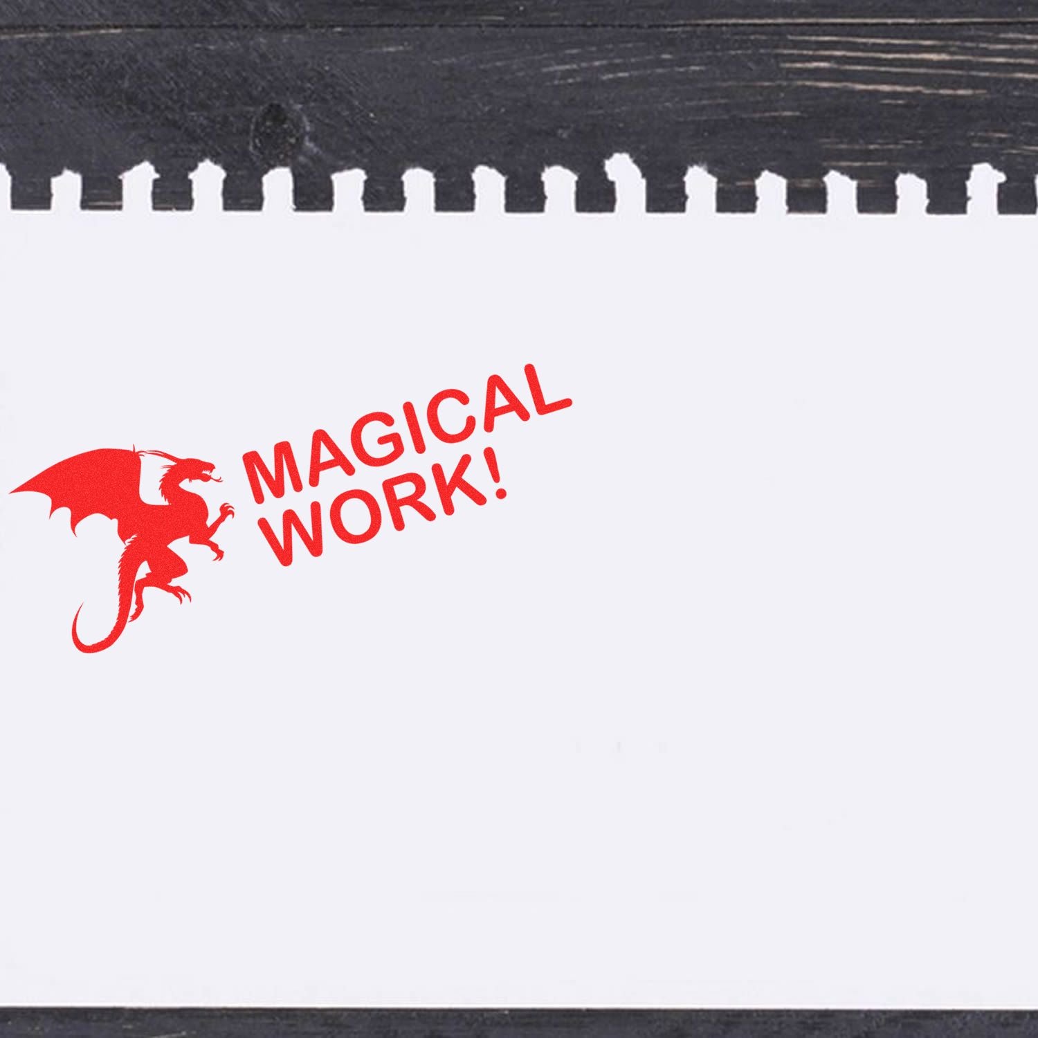 A red dragon and MAGICAL WORK! stamped on white paper using the Dragon Magical Work Rubber Stamp, placed on a dark wooden surface.