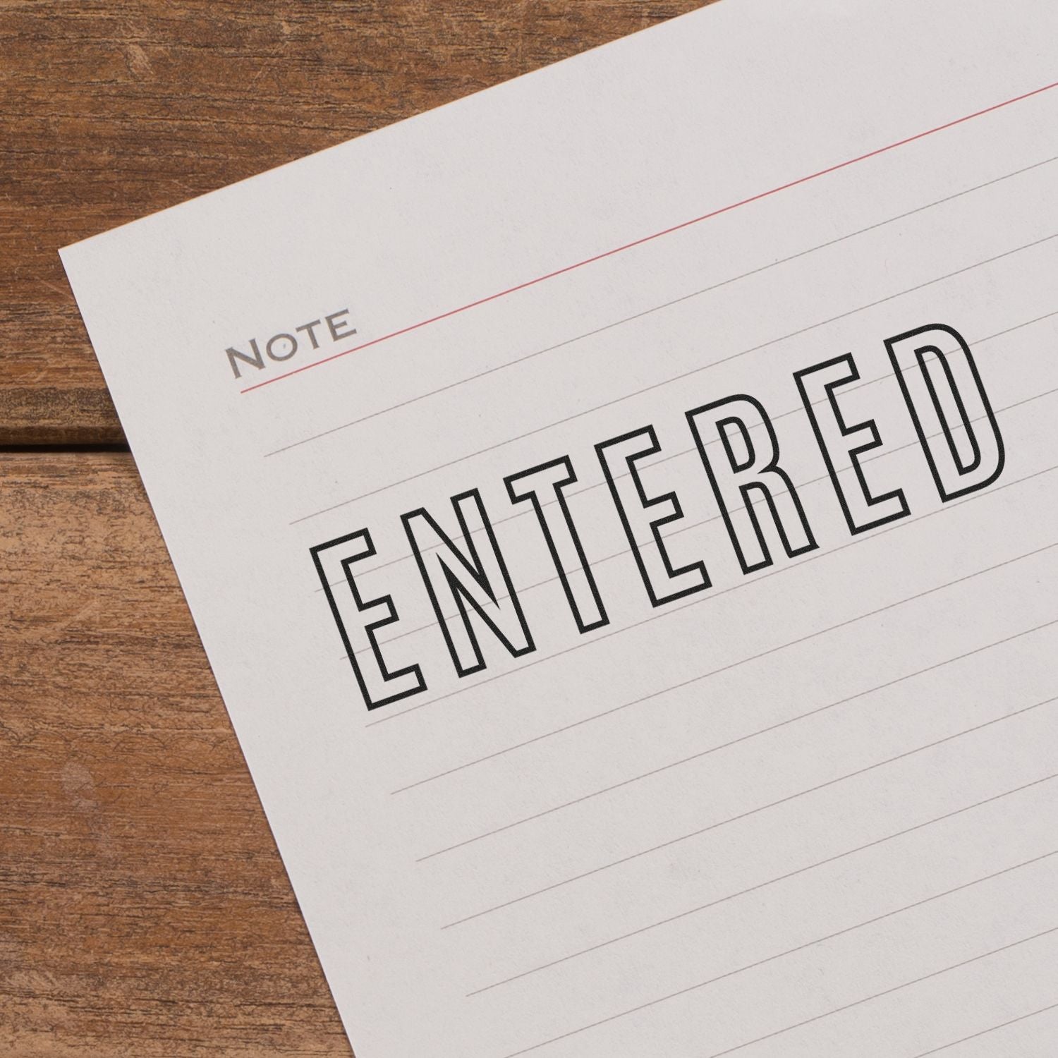 Self Inking Entered Outline Stamp used on a lined paper with the word 'ENTERED' stamped in bold, black outline letters.