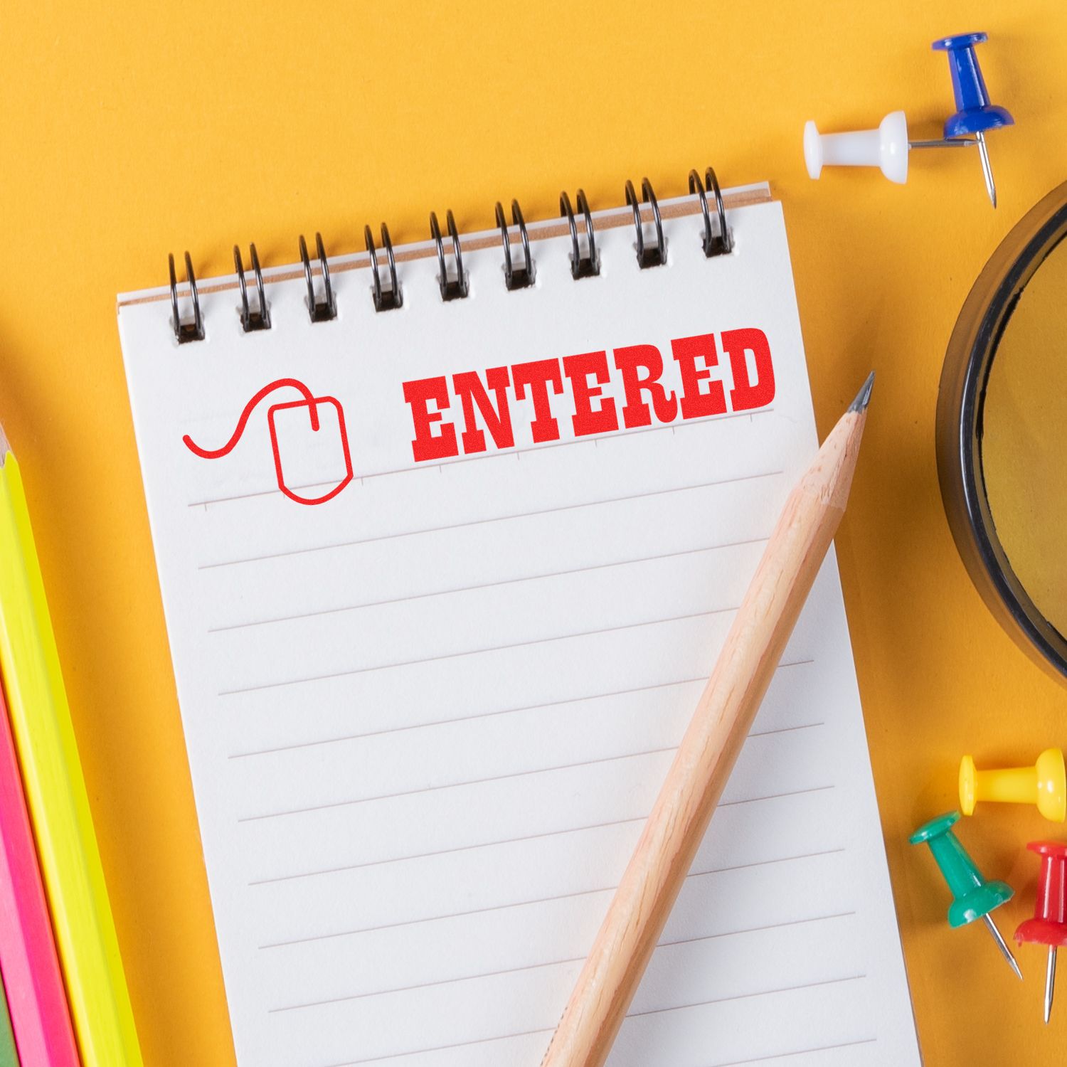 A notepad stamped with ENTERED using the Large Self Inking Entered with Mouse Stamp, surrounded by a pencil, push pins, and colorful markers.