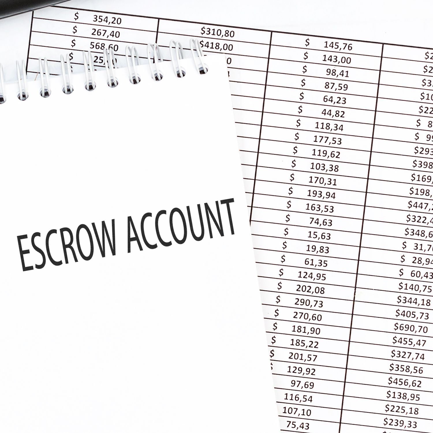 Large Self Inking Escrow Account Stamp used on a notepad with financial documents in the background.