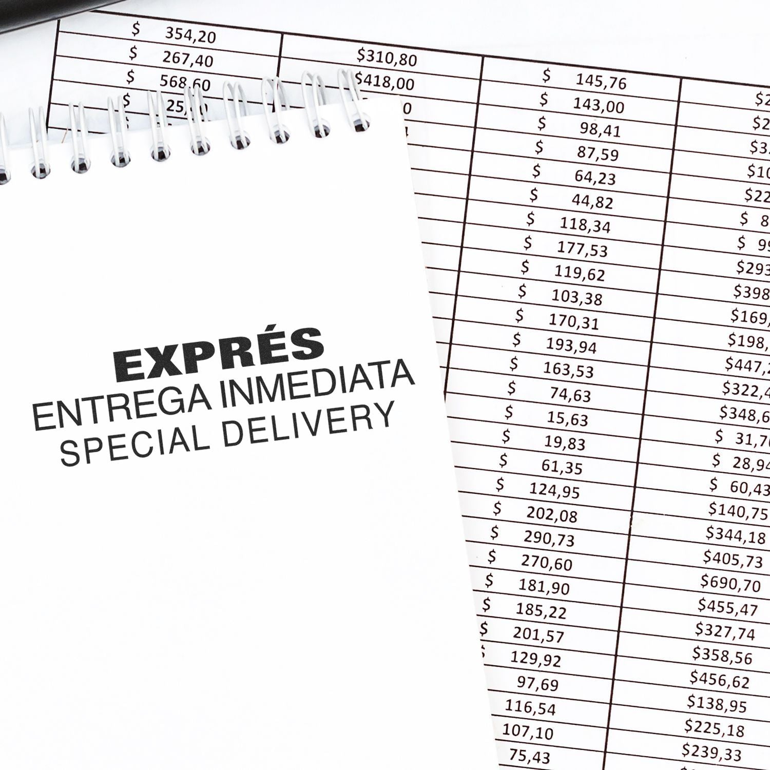 Expres Entrega Inmediata Rubber Stamp used on a notepad with financial documents in the background.