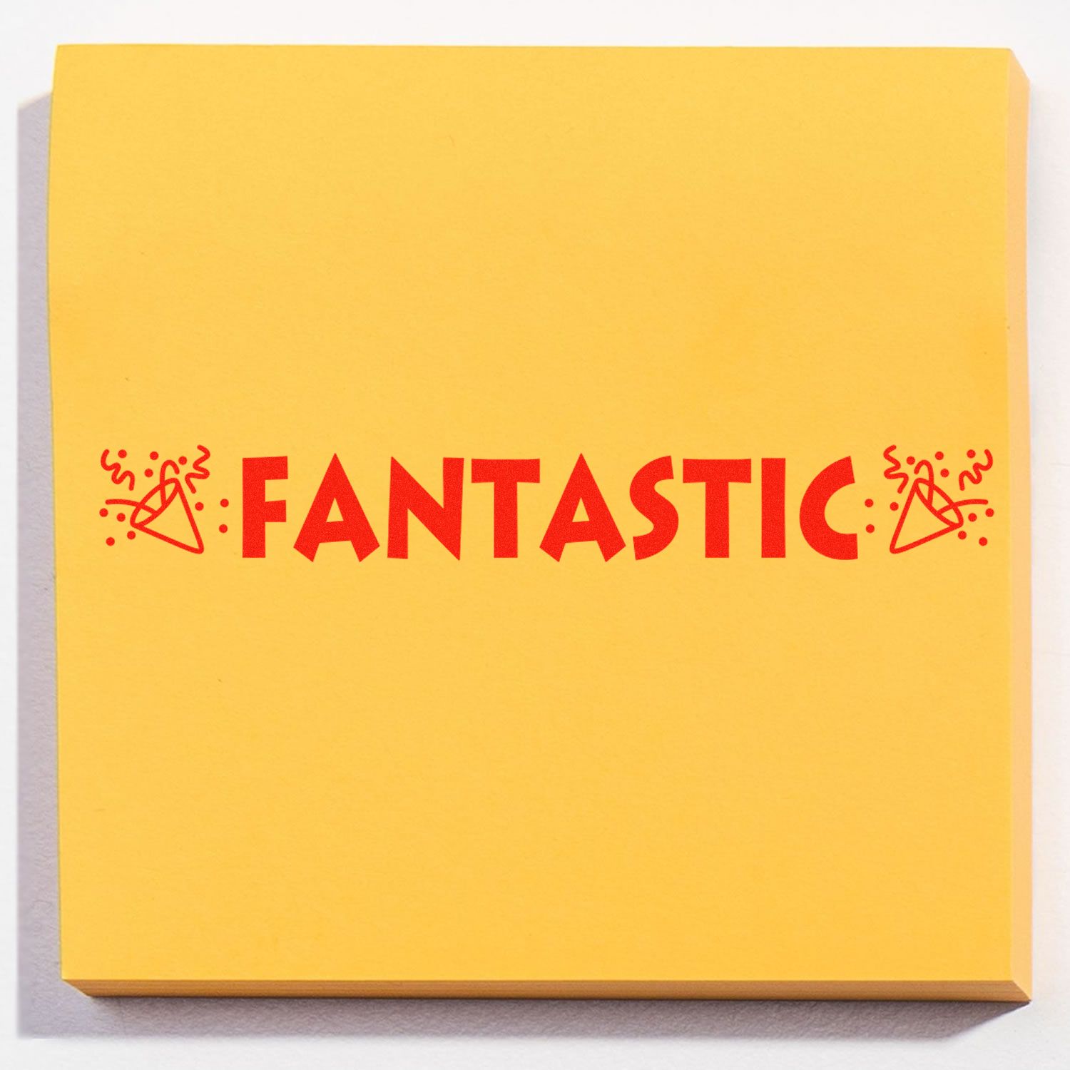 Yellow sticky note stamped with FANTASTIC in red using the Self Inking Fantastic with Icons Stamp, featuring celebratory icons.