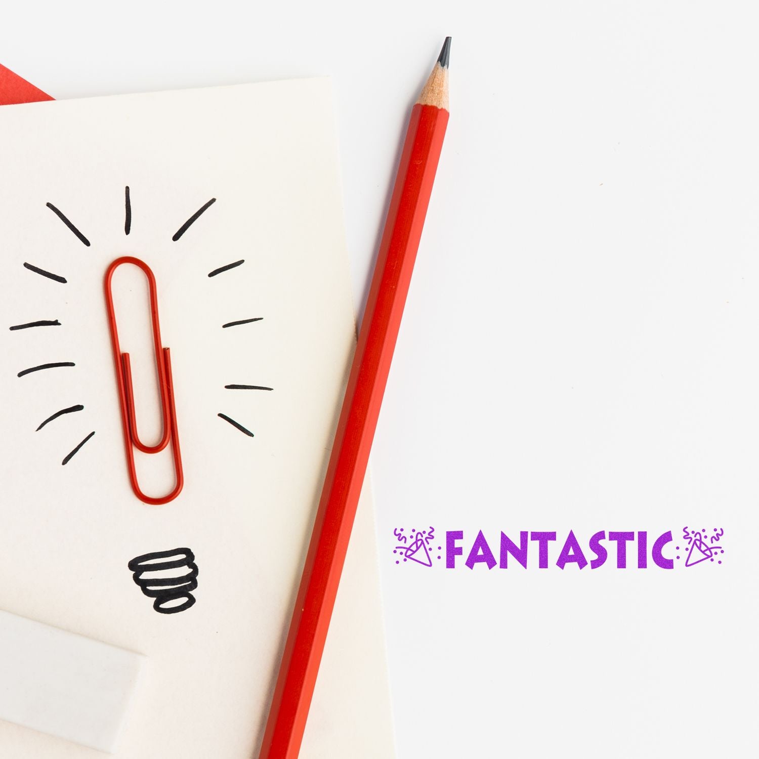 A red pencil and paperclip on a notepad with a lightbulb drawing, next to the Fantastic with Icons Rubber Stamp text in purple.