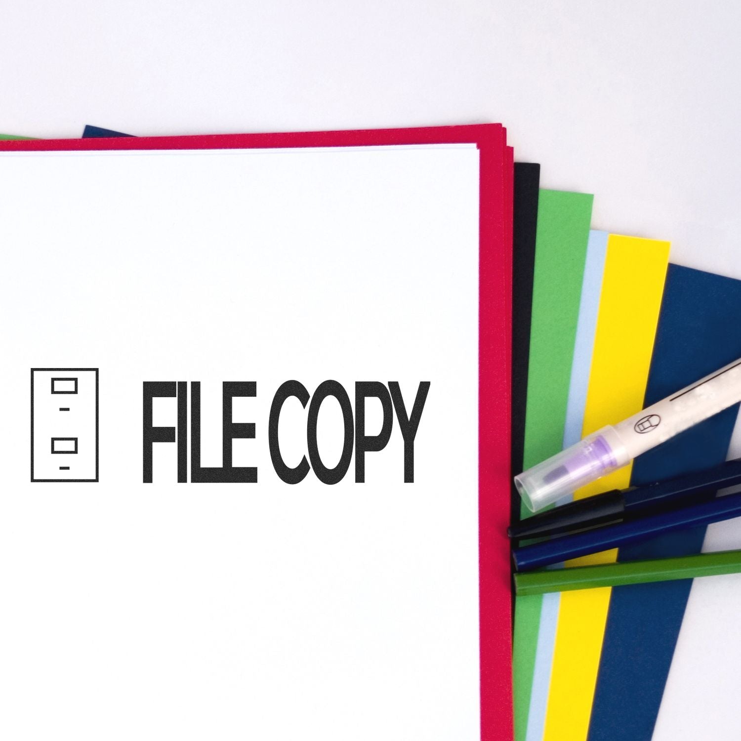 File Copy with Drawer Rubber Stamp used on a white document, surrounded by colorful folders and pens.