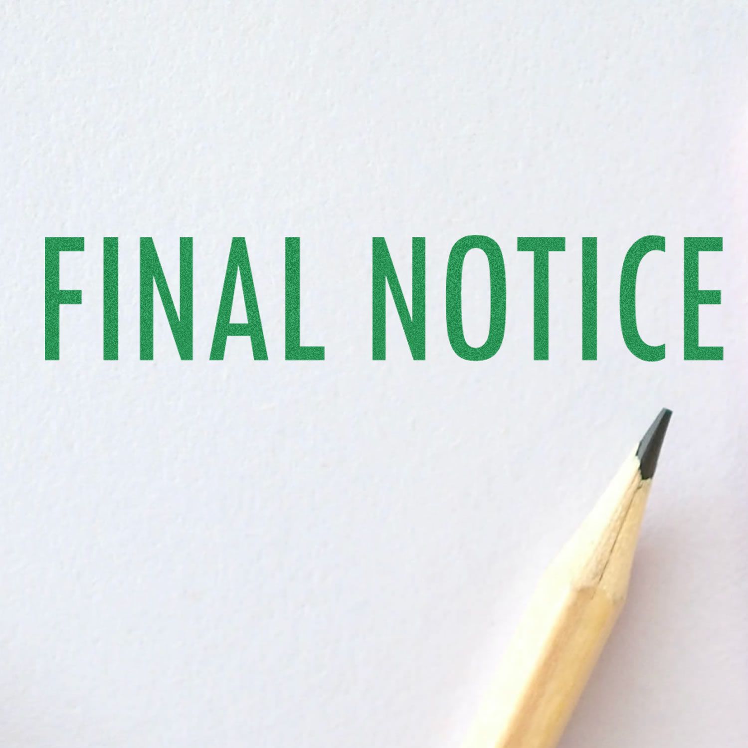 Final Notice Rubber Stamp imprint in green ink on white paper, with a sharpened pencil tip visible in the bottom right corner.