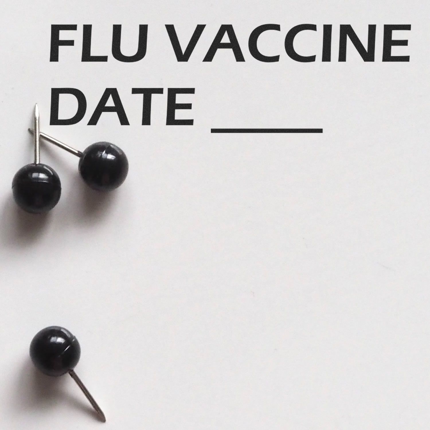 Large Self Inking Flu Vaccine Date Stamp in use, with black push pins on a white paper labeled 'FLU VACCINE DATE' and a blank line.