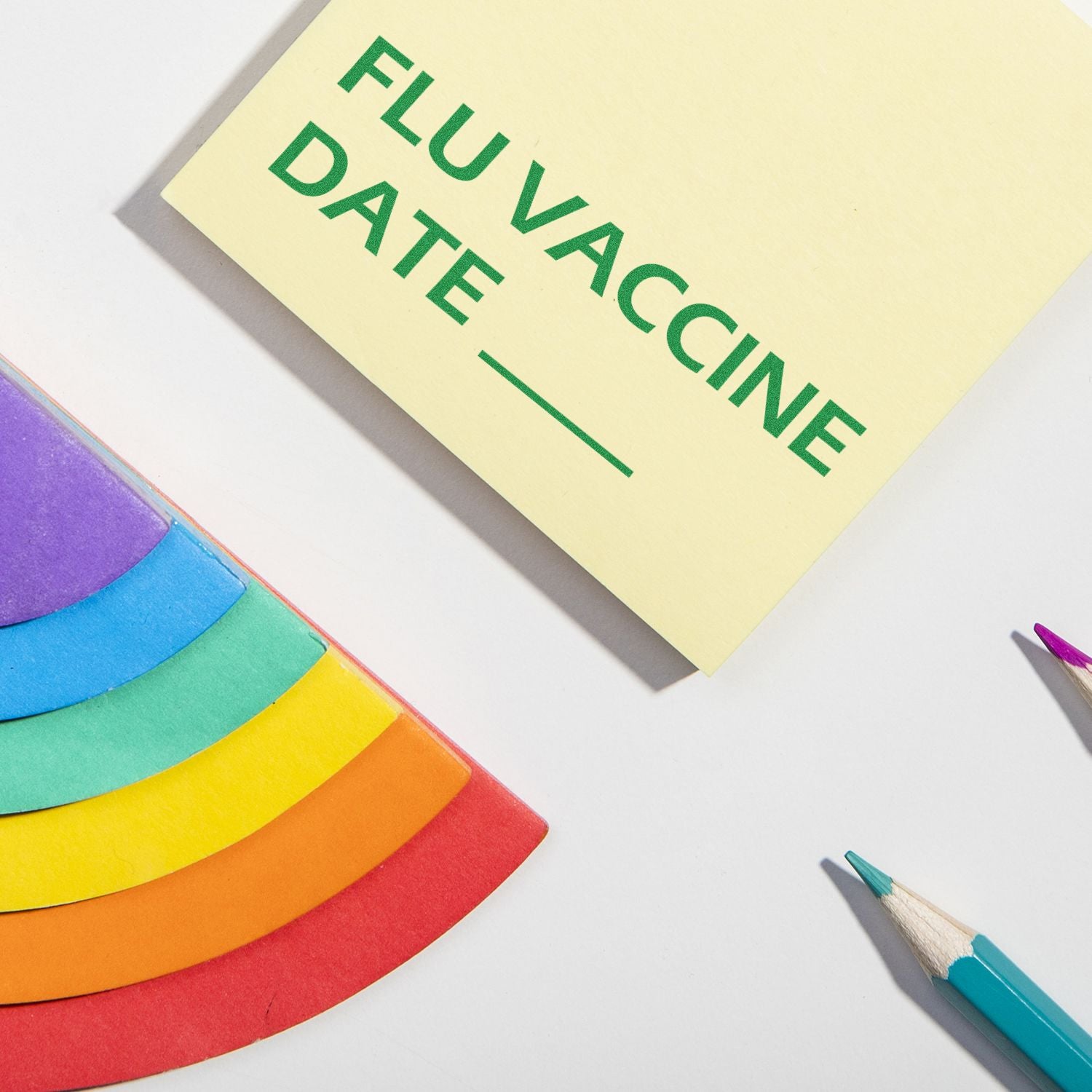 Large Self Inking Flu Vaccine Date Stamp in use on a yellow card with FLU VACCINE DATE text, surrounded by colorful paper and pencils.