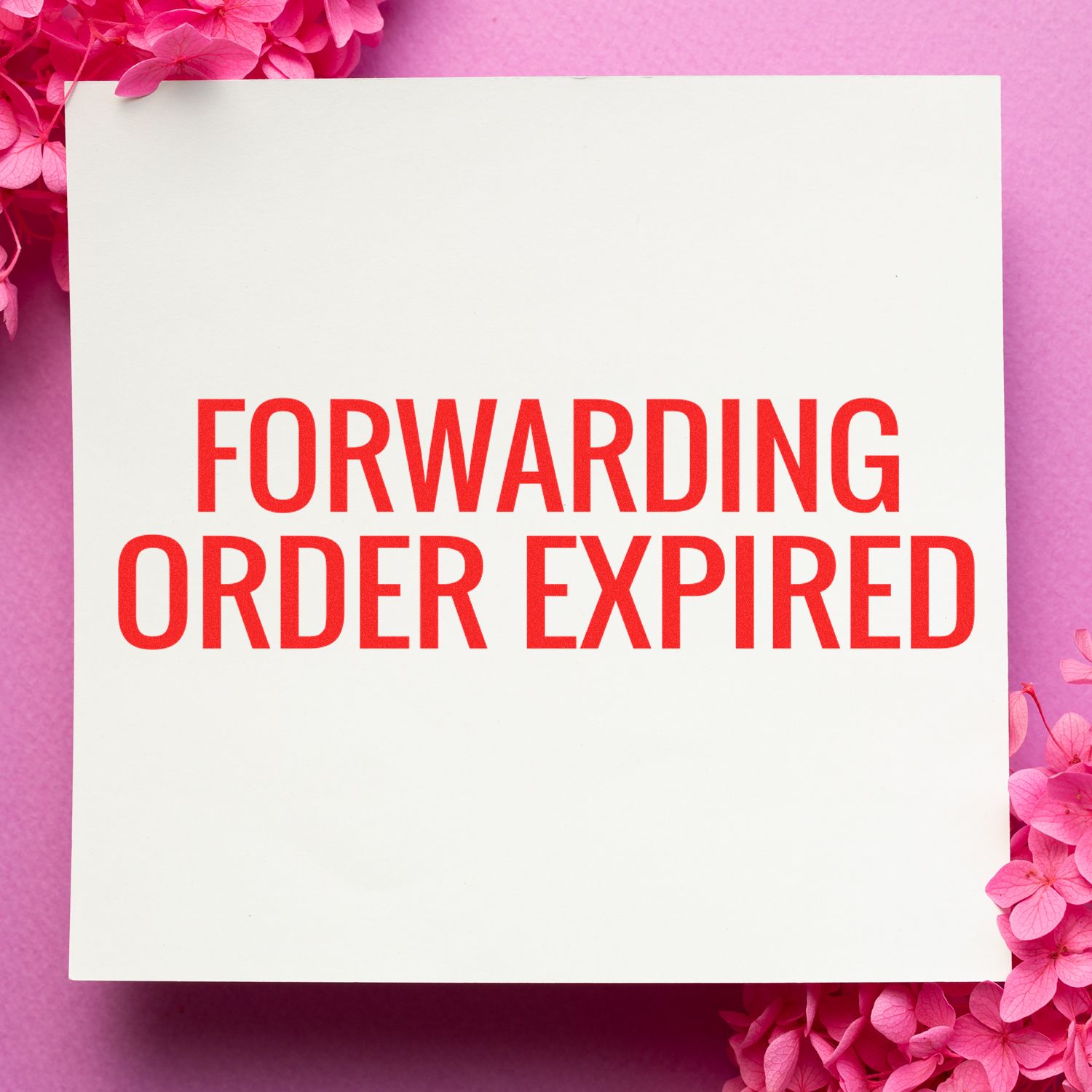 A white paper stamped with Forwarding Order Expired in red ink using the Self Inking Forwarding Order Expiring Stamp, surrounded by pink flowers.