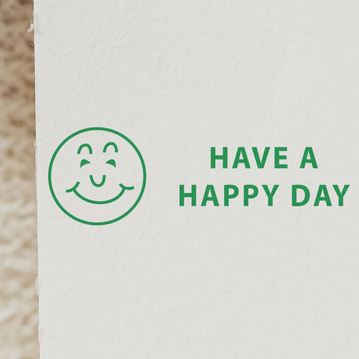 Have a Happy Day Rubber Stamp used on white paper, featuring a smiling face and the text 'HAVE A HAPPY DAY' in green ink.