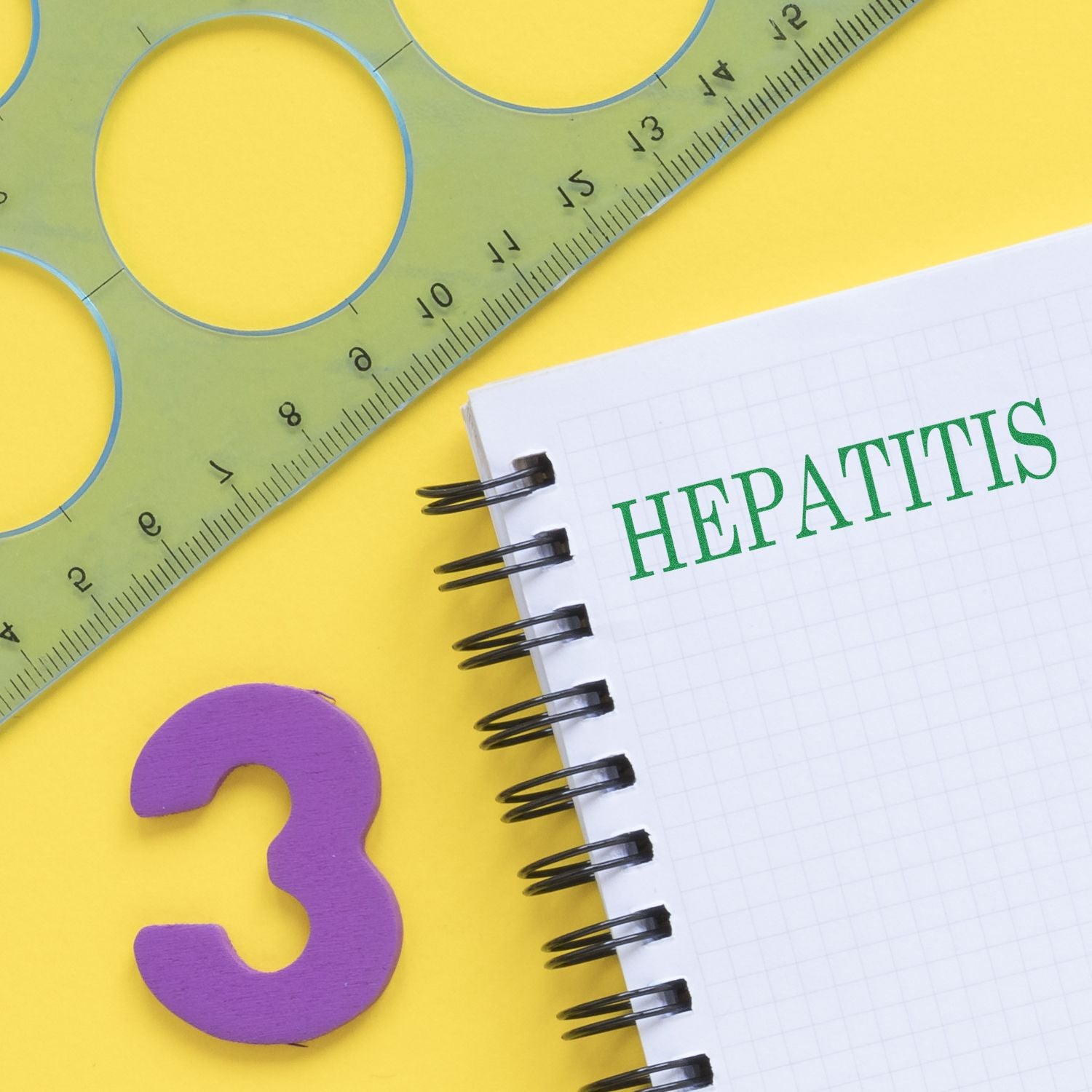 Hepatitis Rubber Stamp used on a spiral notebook with a green ruler and a purple number 3 on a yellow background.