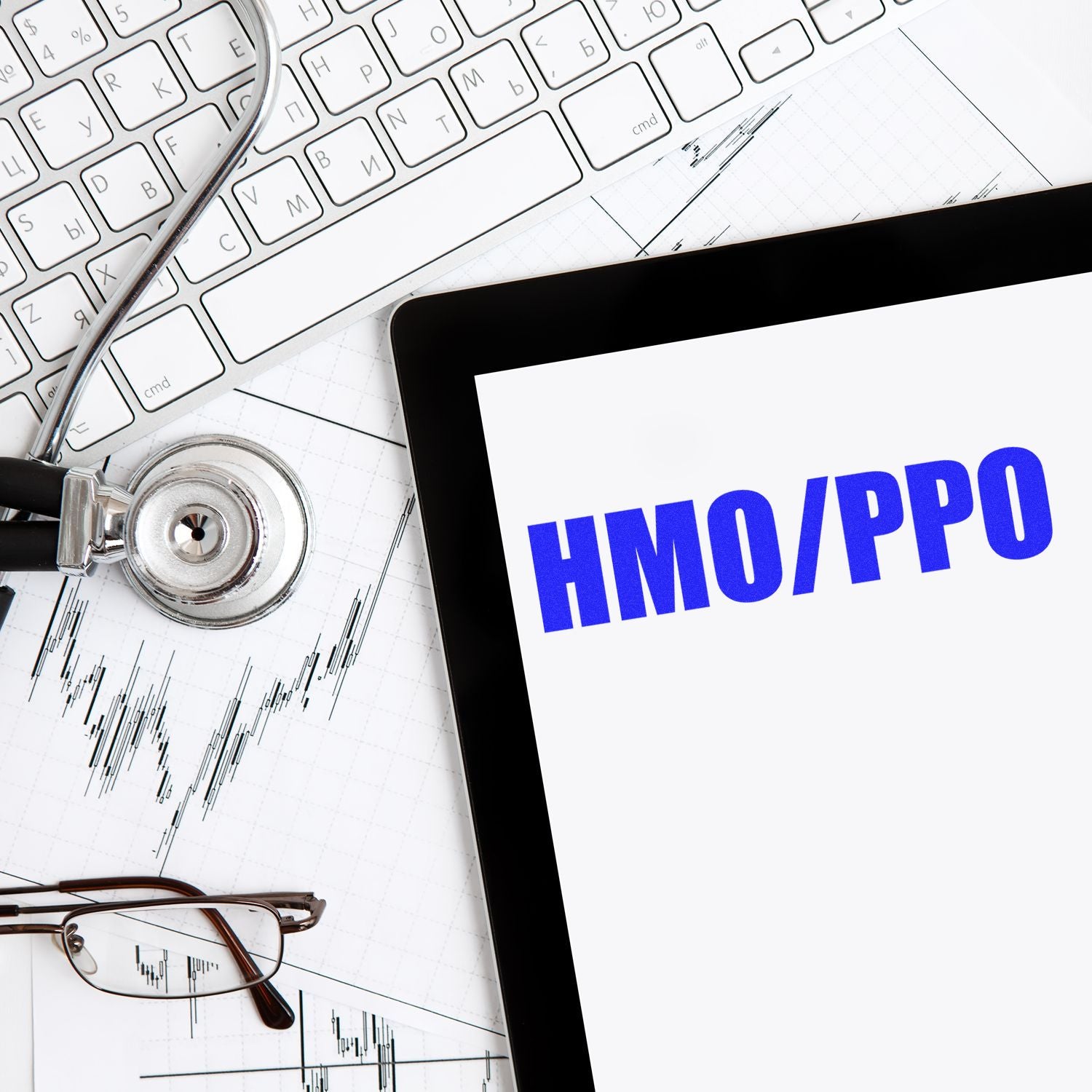 Slim Pre-Inked HMO/PPO Stamp on a tablet screen, surrounded by a stethoscope, keyboard, glasses, and financial charts.