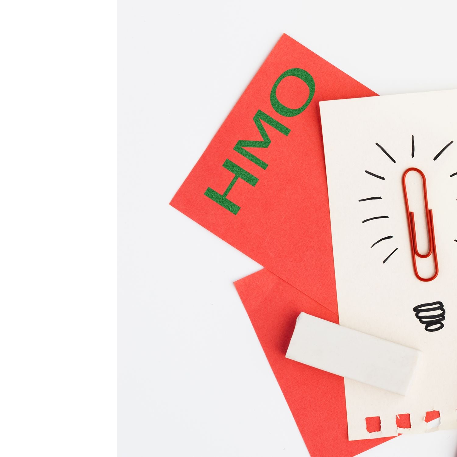 Red and white papers with a Slim Pre-Inked HMO Stamp, featuring a red paperclip and light bulb doodle on the white paper.