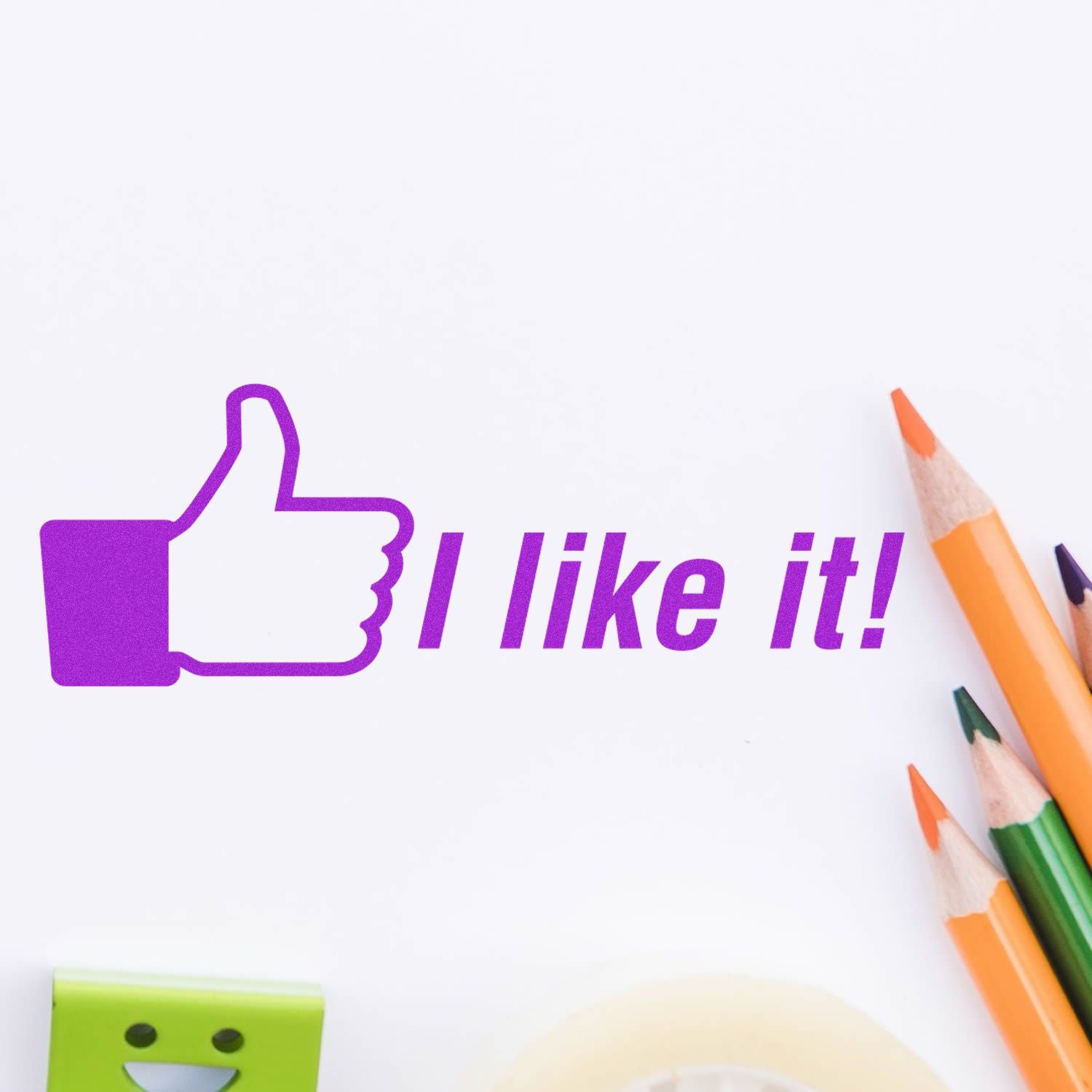 I like it Rubber Stamp in use, showing a purple thumbs-up and text 'I like it!' on white paper, surrounded by colorful pencils and stationery.