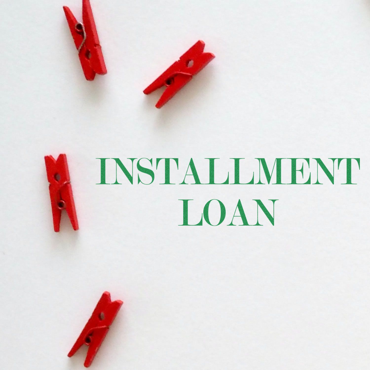 Red clothespins on white background with green text 'Installment Loan' in the center, highlighting Slim Pre-Inked Installment Loan Stamp.