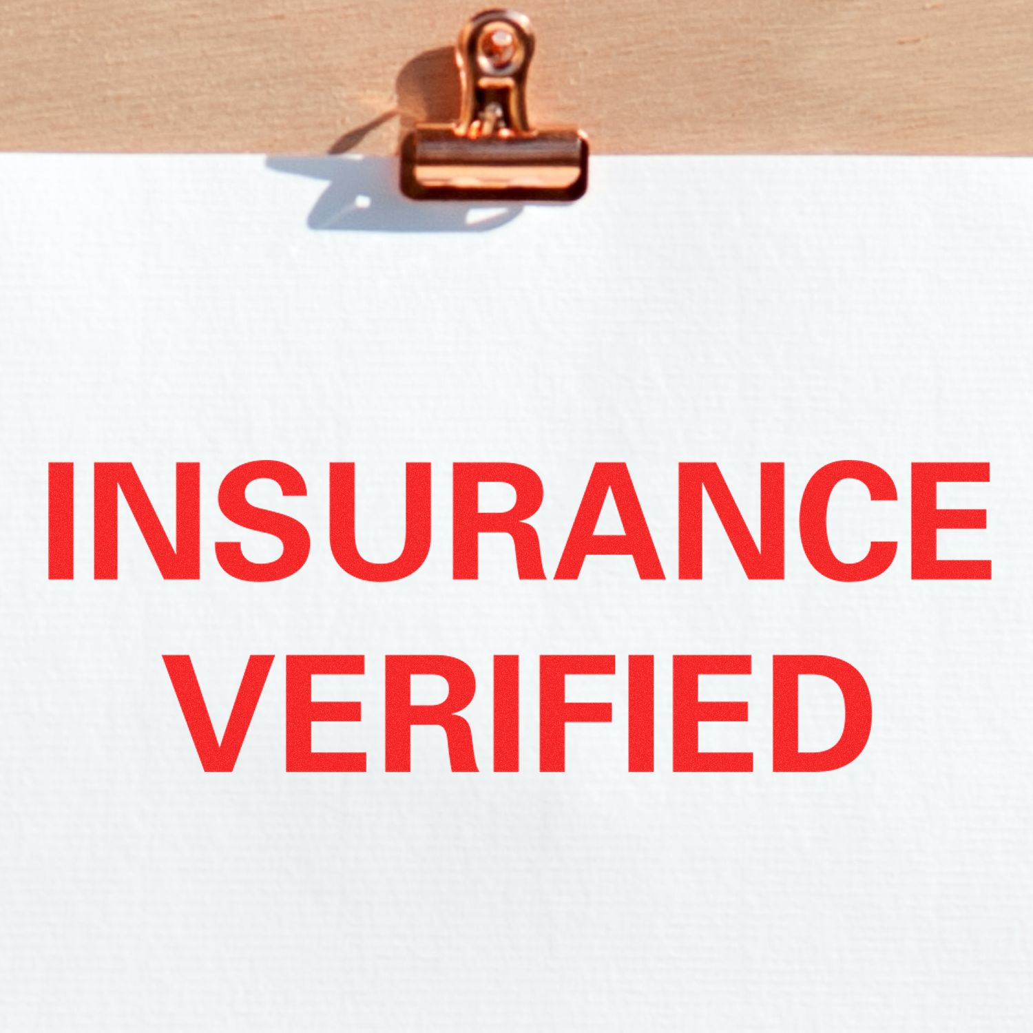 Self Inking Insurance Verified Stamp in use, displaying bold red text 'INSURANCE VERIFIED' on a white sheet clipped to a wooden board.