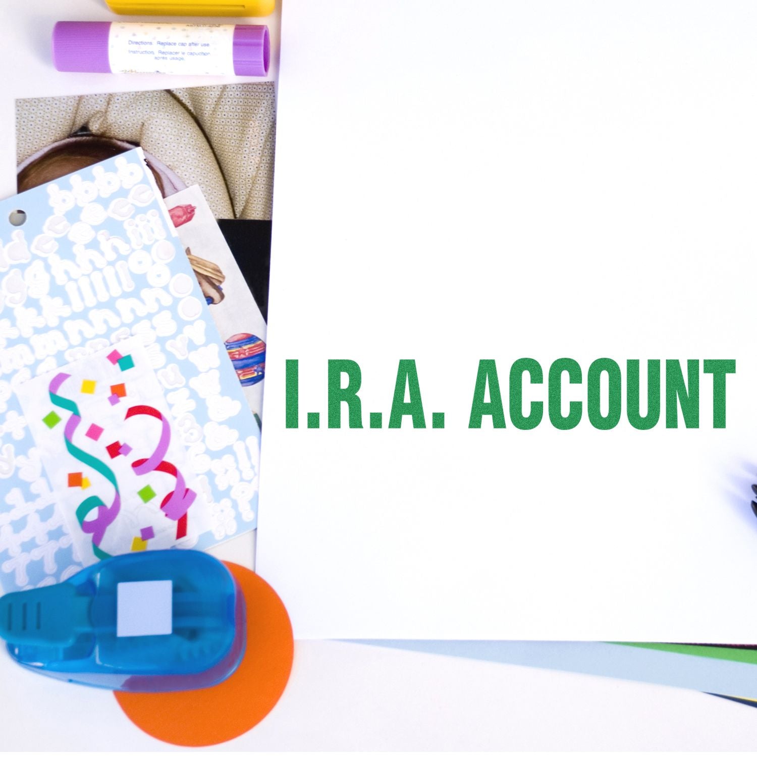 I.R.A. Account Rubber Stamp in use on a white paper, surrounded by colorful office supplies and stickers.