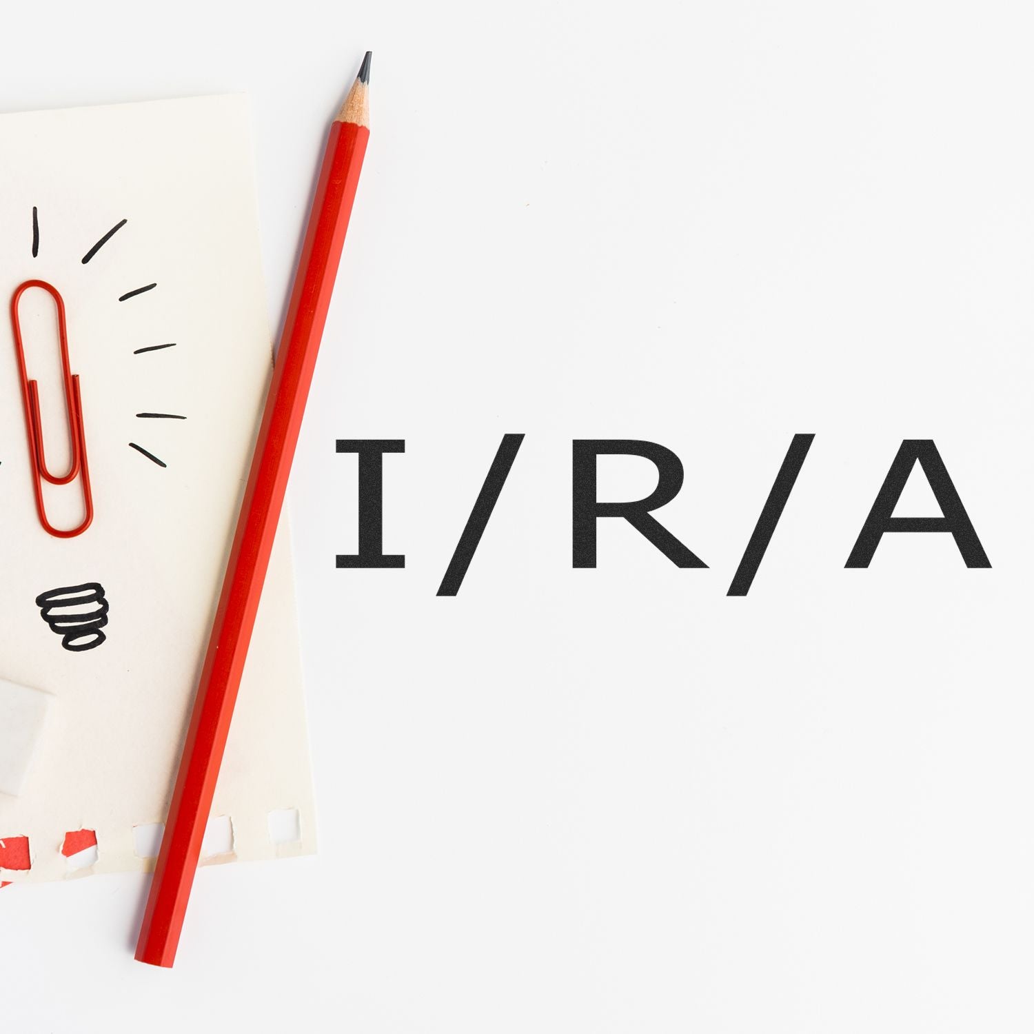 Slim Pre-Inked I/R/A Stamp next to a red pencil and paper clip on a white background.