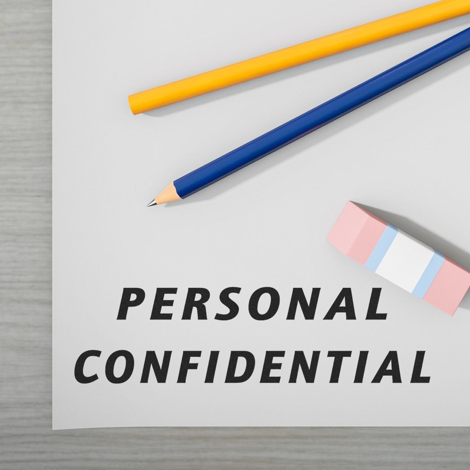 A paper stamped with PERSONAL CONFIDENTIAL using the _Italic Personal Confidential Rubber Stamp_, next to pencils and an eraser.