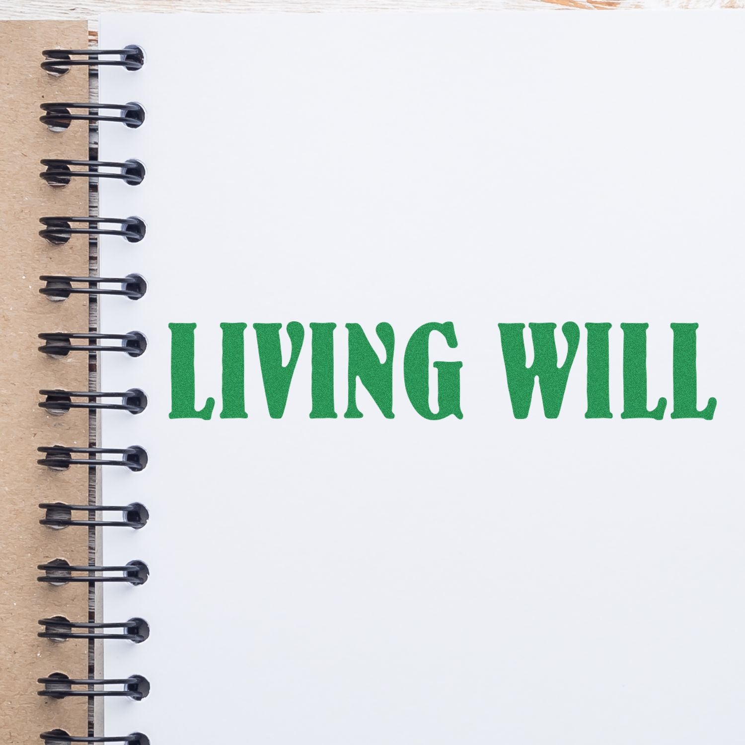 Living Will Rubber Stamp impression in green ink on a white spiral-bound notebook page.