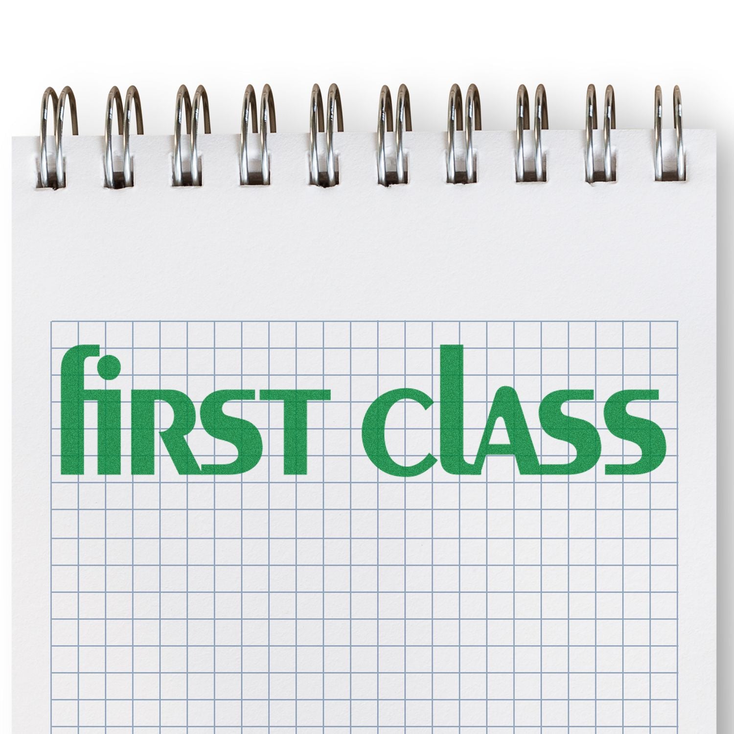 Lower case first class rubber stamp in green ink on a spiral-bound graph paper notebook.