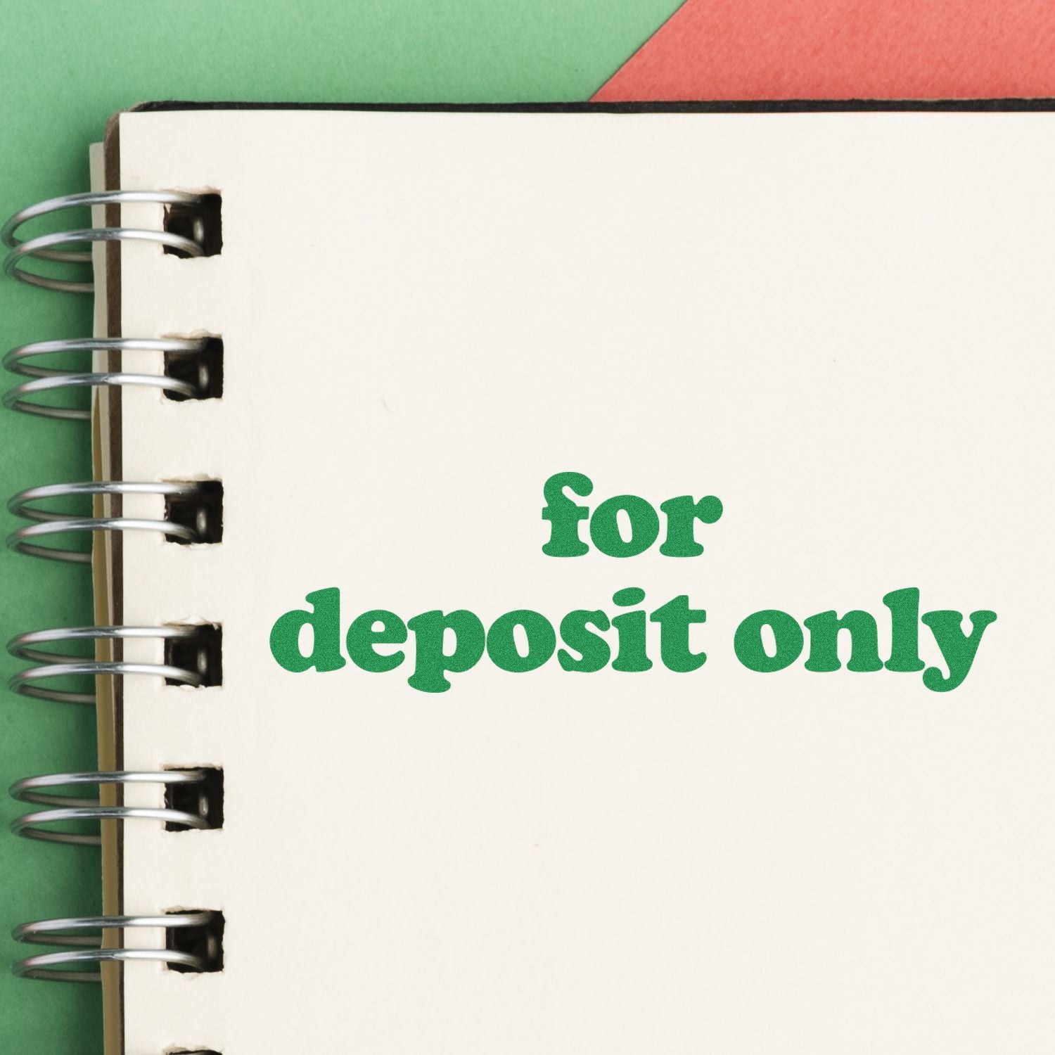 Lowercase for deposit only rubber stamp impression on a white notebook page with a green and red background.