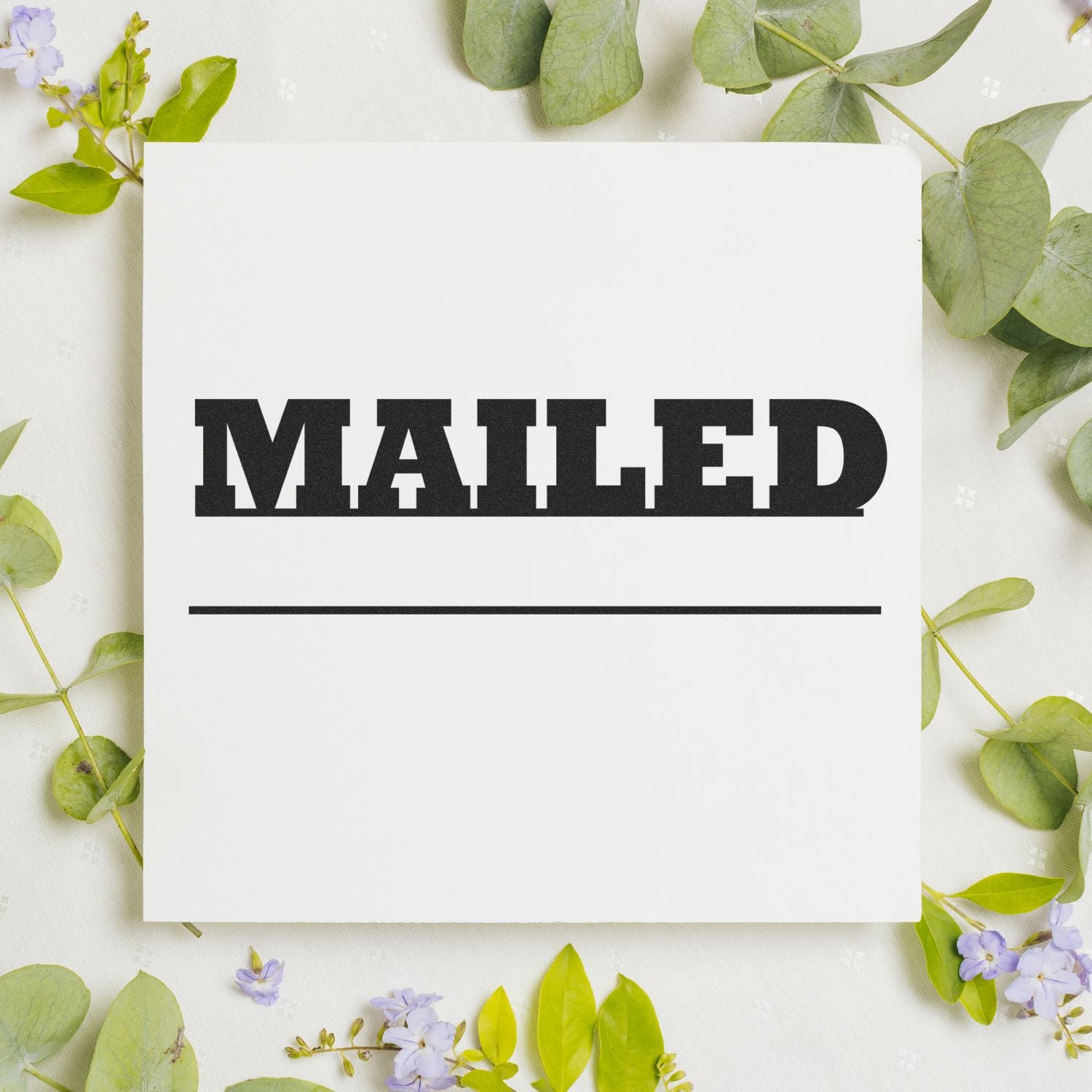 Mailed with Date Line Rubber Stamp on white paper surrounded by green leaves and small purple flowers.