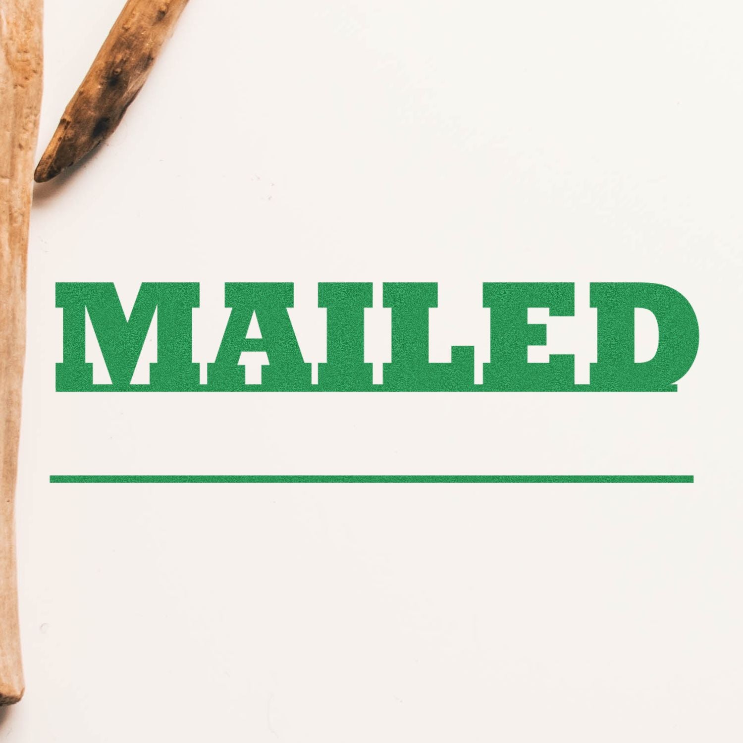 Green Mailed with Date Line Rubber Stamp impression on white paper, with a wooden handle partially visible on the left.