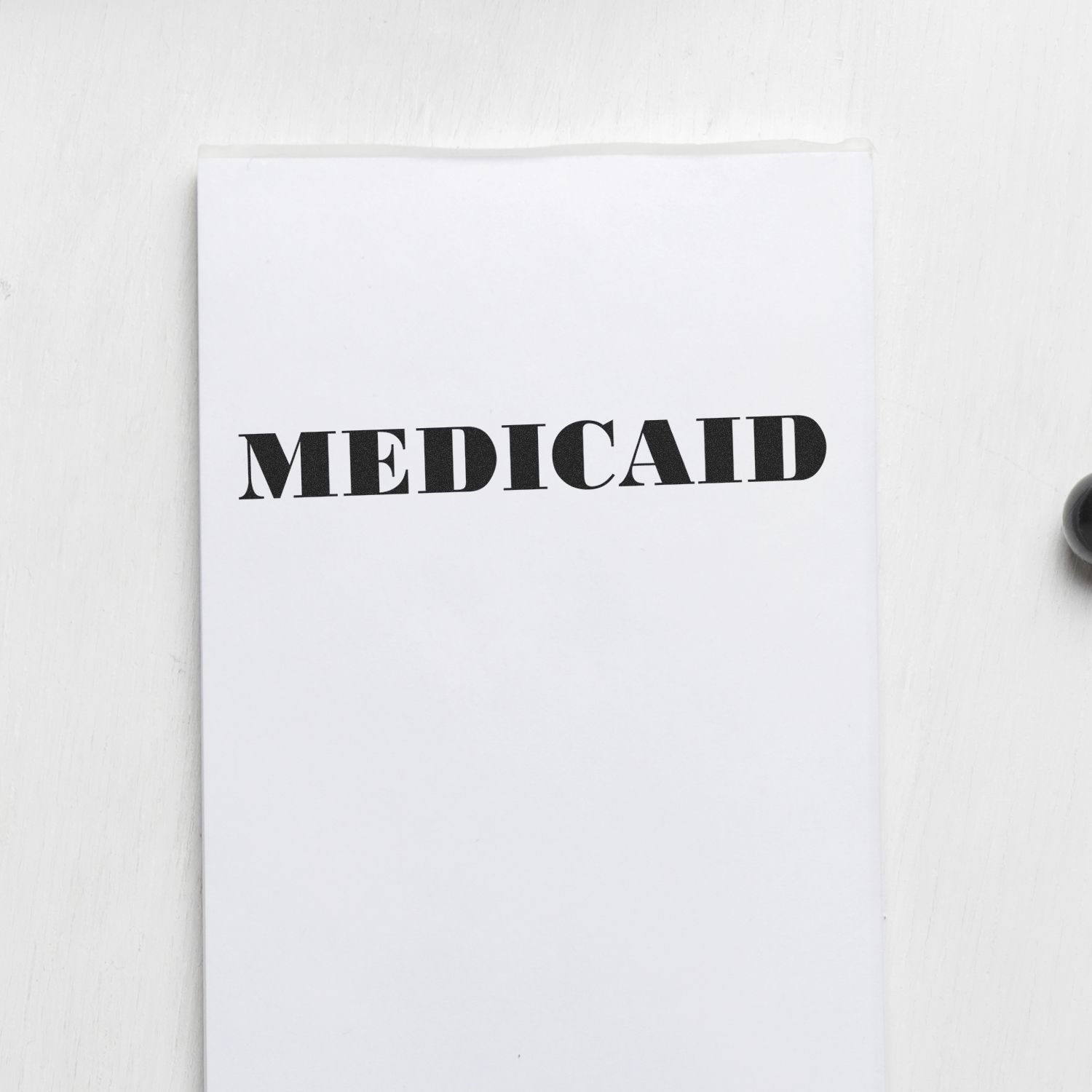 Medicaid Rubber Stamp imprint on a white sheet of paper, with the word 'MEDICAID' clearly visible in bold black letters.