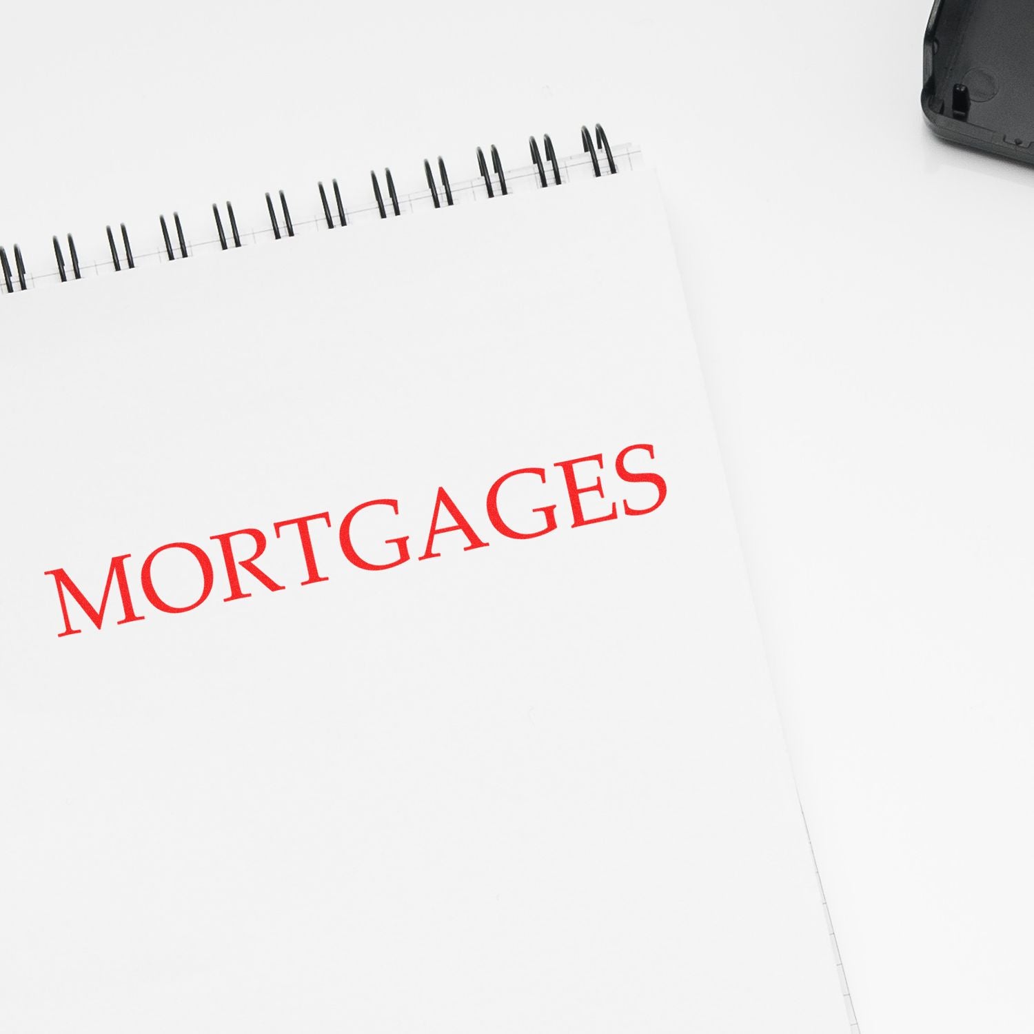 Large Mortgages Rubber Stamp in red ink on a white notepad, with a black ink pad partially visible in the corner.